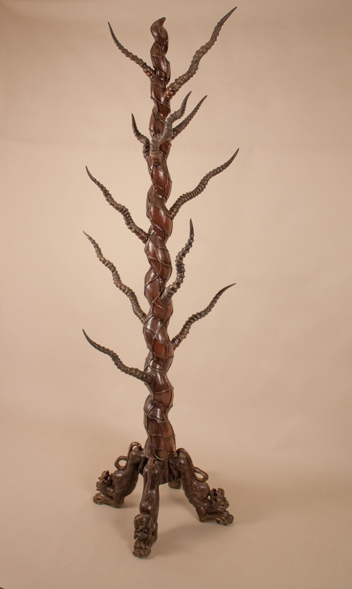 Handcrafted from solid rosewood, this hat or coat stand has 11 authentic Indian gazelle horns on which to hang your hat. The serpentine movement of the stand blends well with the organic shape of the horns. The rack stands 75.50 inches tall on four
