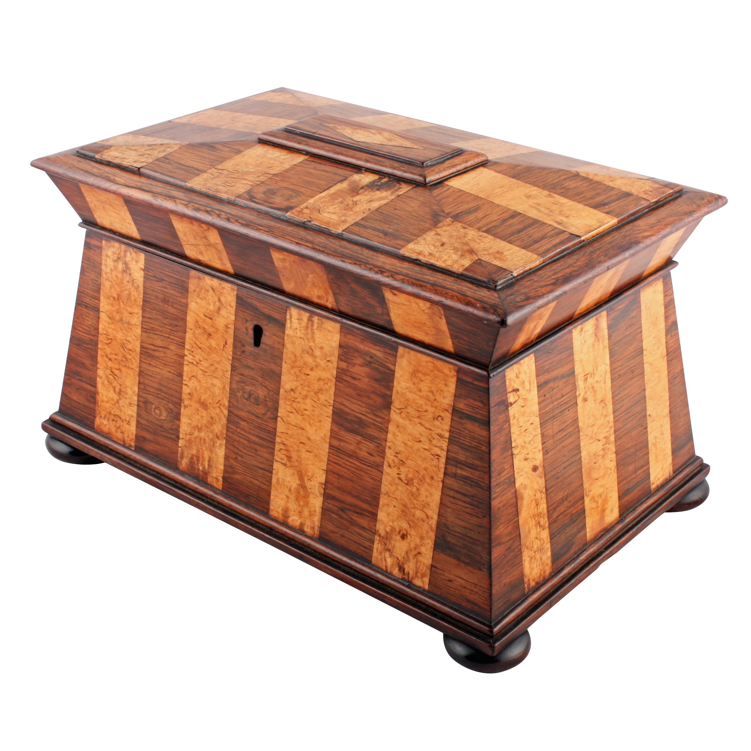 Rosewood and karellian birch tea caddy.


A William IV rosewood and karellian birch veneered sarcophagus shaped tea caddy.

The caddy is mostly rosewood with panels of karellian birch veneer inside and out.

The caddy is raised on flat bun