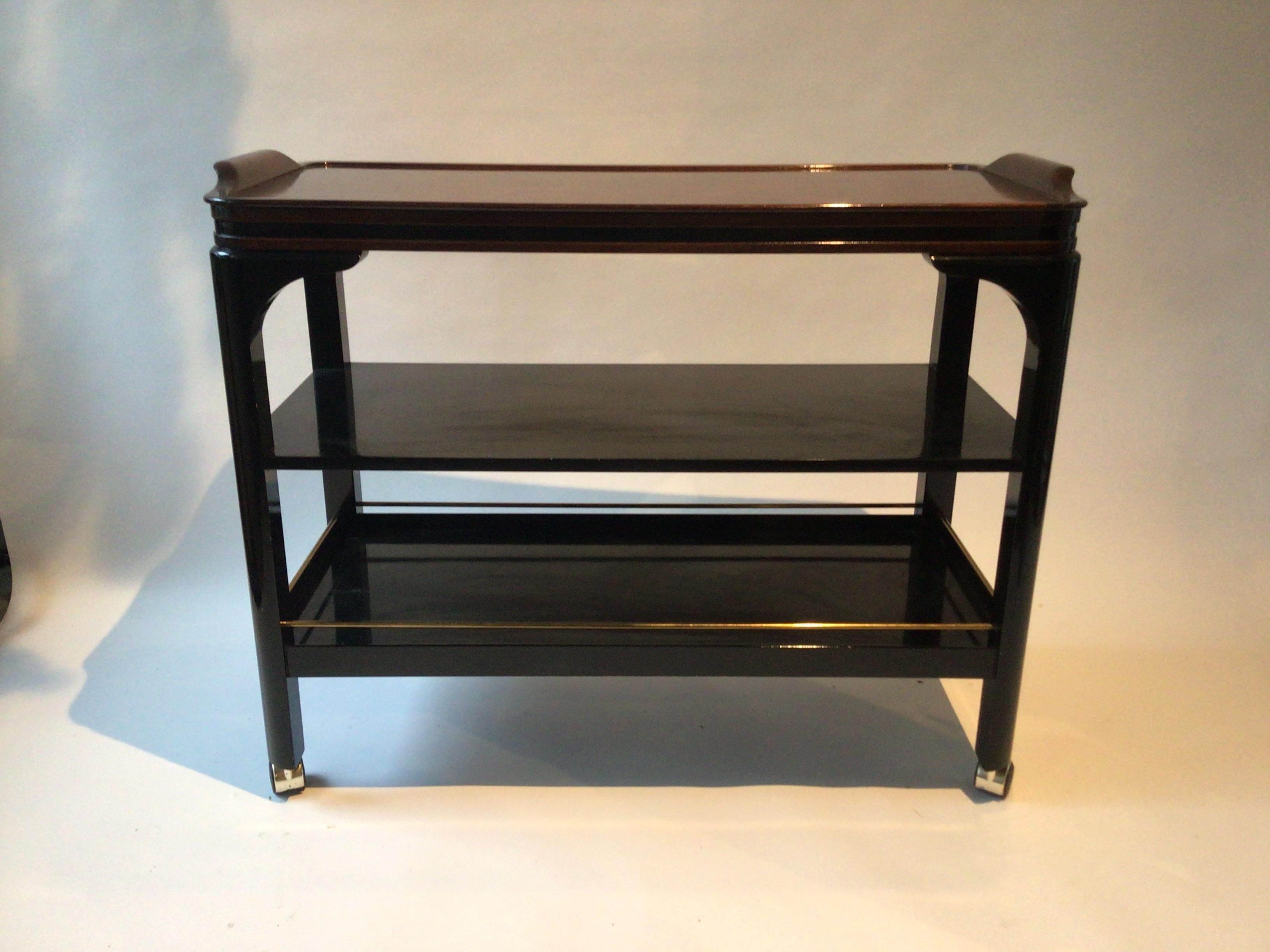 1980s Custom made bar cart on casters. From a NYC penthouse apartment. Original cost was 5000 dollars. Rosewood top, black lacquered shelves. Brass railing.