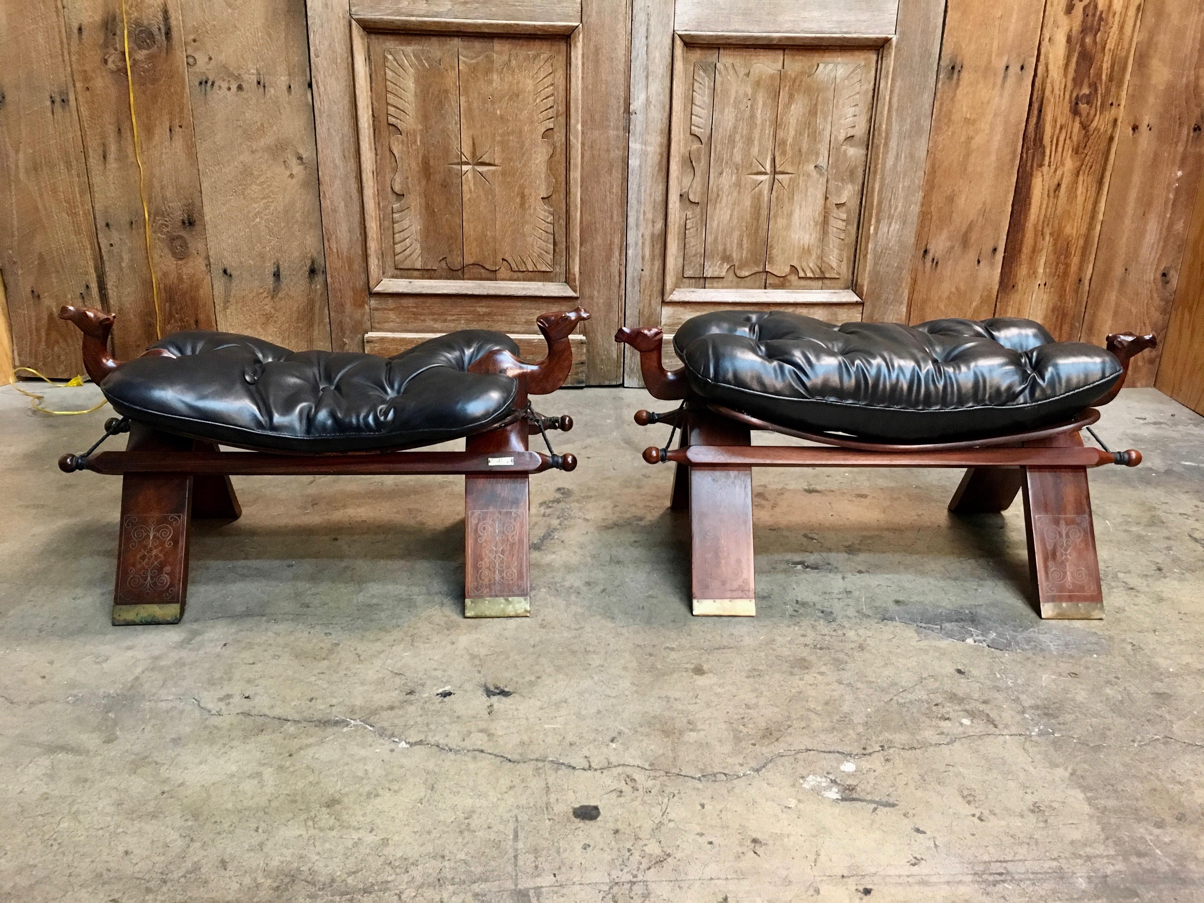 Carved Indian rosewood foot stools with tufted black leather and brass inlay by old school furniture manufacturing Company, M. Hayat & Bros is over 140 years old and produces the most beautiful handcrafted solid Rose wood furniture in the world.