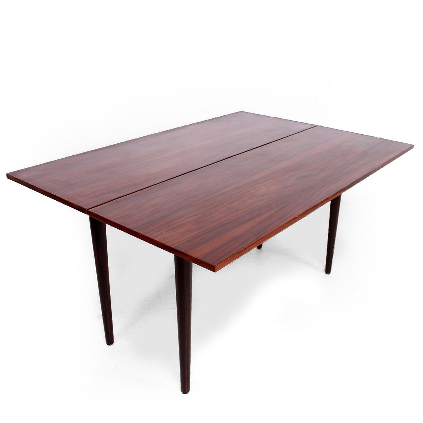 For your consideration a Mid-Century Modern console/dining table made of rosewood and Macassar wood.

The original configuration is a console table which can be expanded into a dining table. 

Unmarked. 
Measures:
31