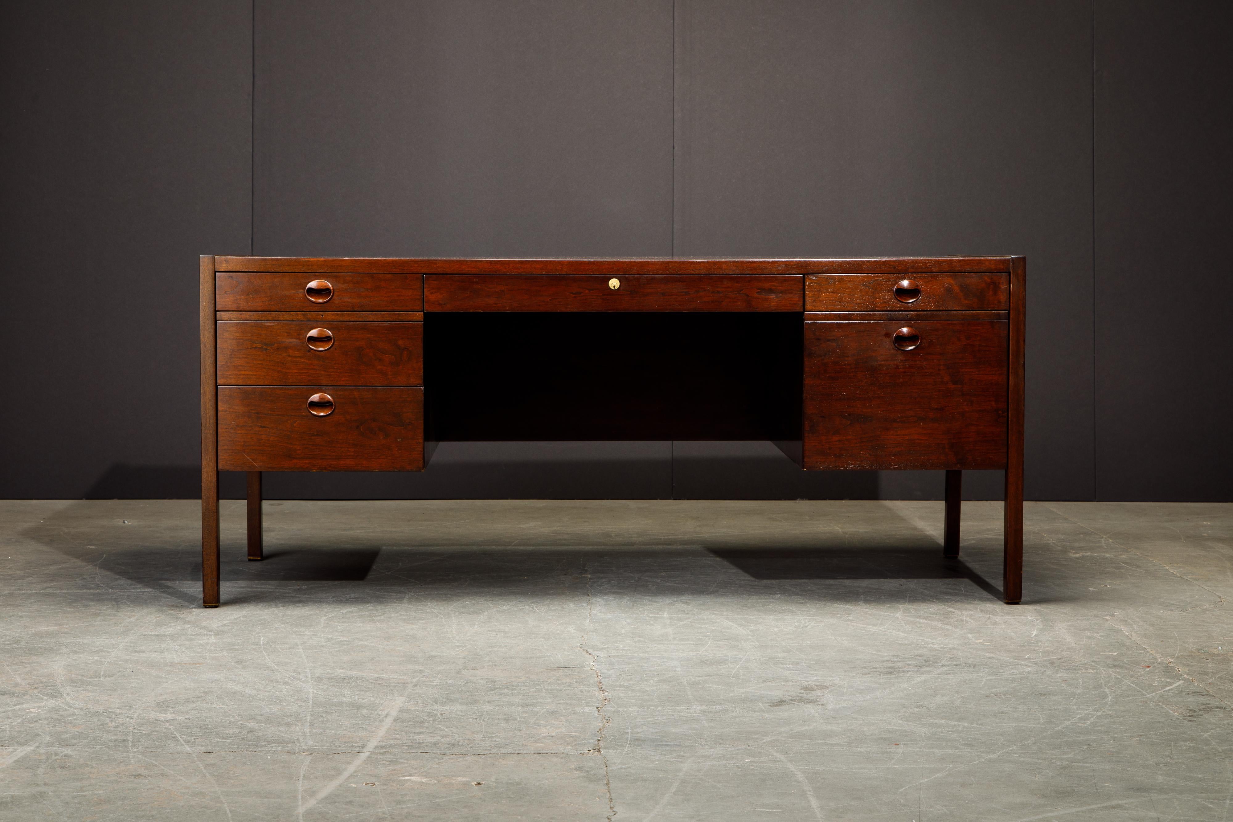 This grand executive desk by Edward Wormley for Dunbar features beautiful Rosewood and Mahogany with brass feet, designed and made in the 1960s. Such incredible use of luxury materials and quality craftsmanship as you would expect from Dunbar in the