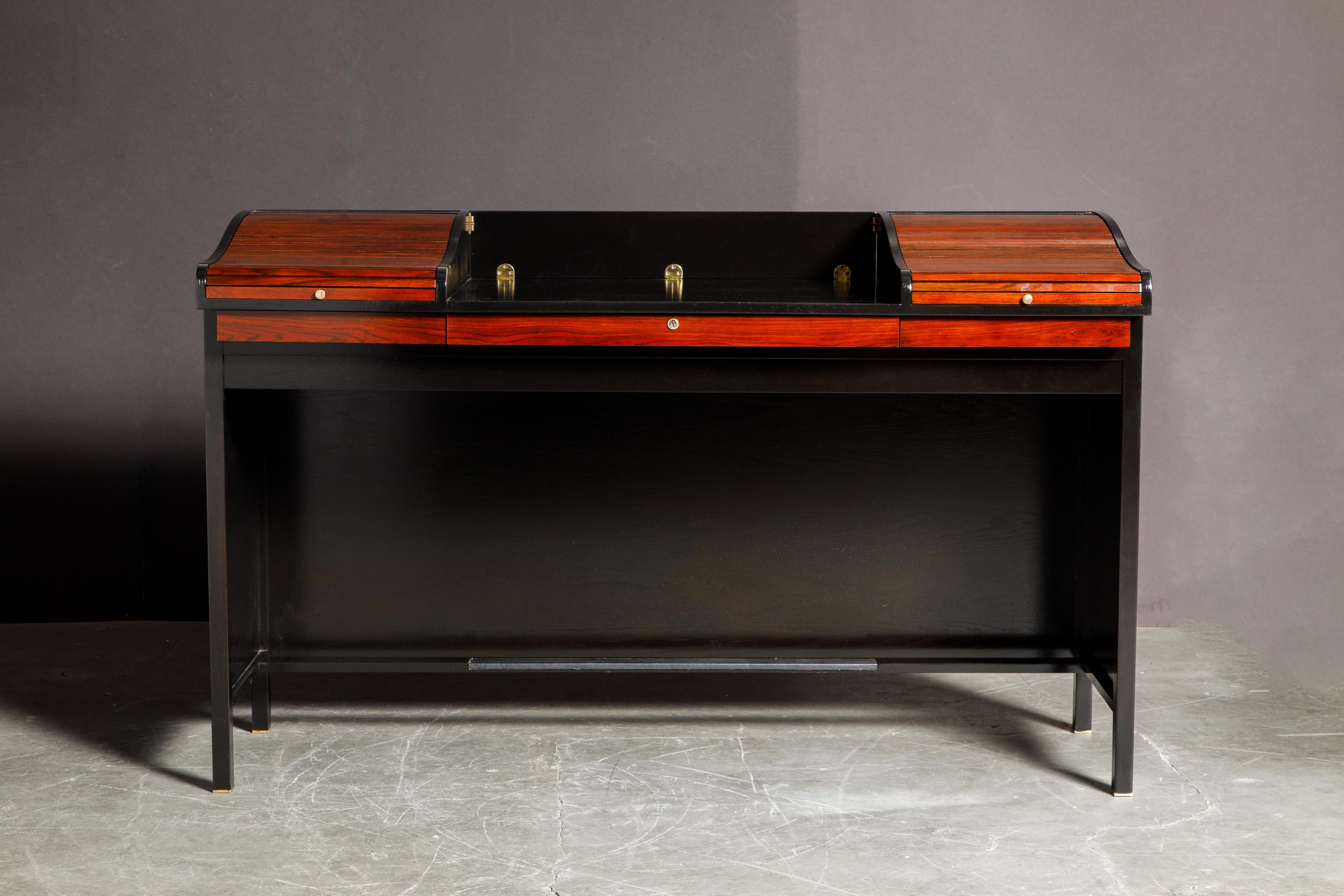 This spectacular fully restored and sought-after model #452 'Roll Top' desk was designed by Edward Wormley for Dunbar and features beautifully grained Rosewood and Ebonized Mahogany, designed and made in the 1960s. Most examples of this design are