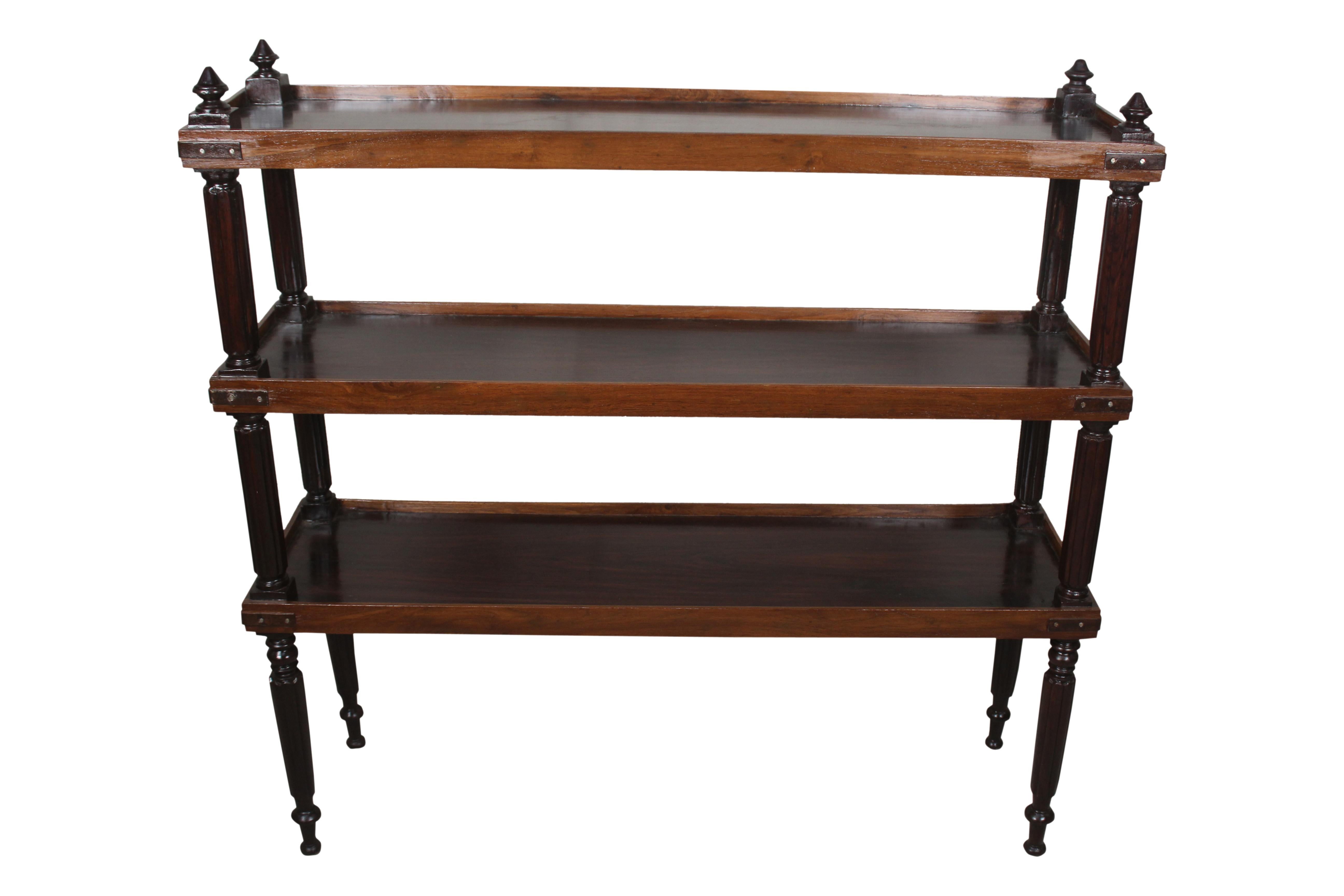 A rosewood bookcase shelf or étagère with mahogany raised borders which create a secure lip around the edges. Features include iron strap corners, beveled side supports and turned feet. Colonial British, 1940s.