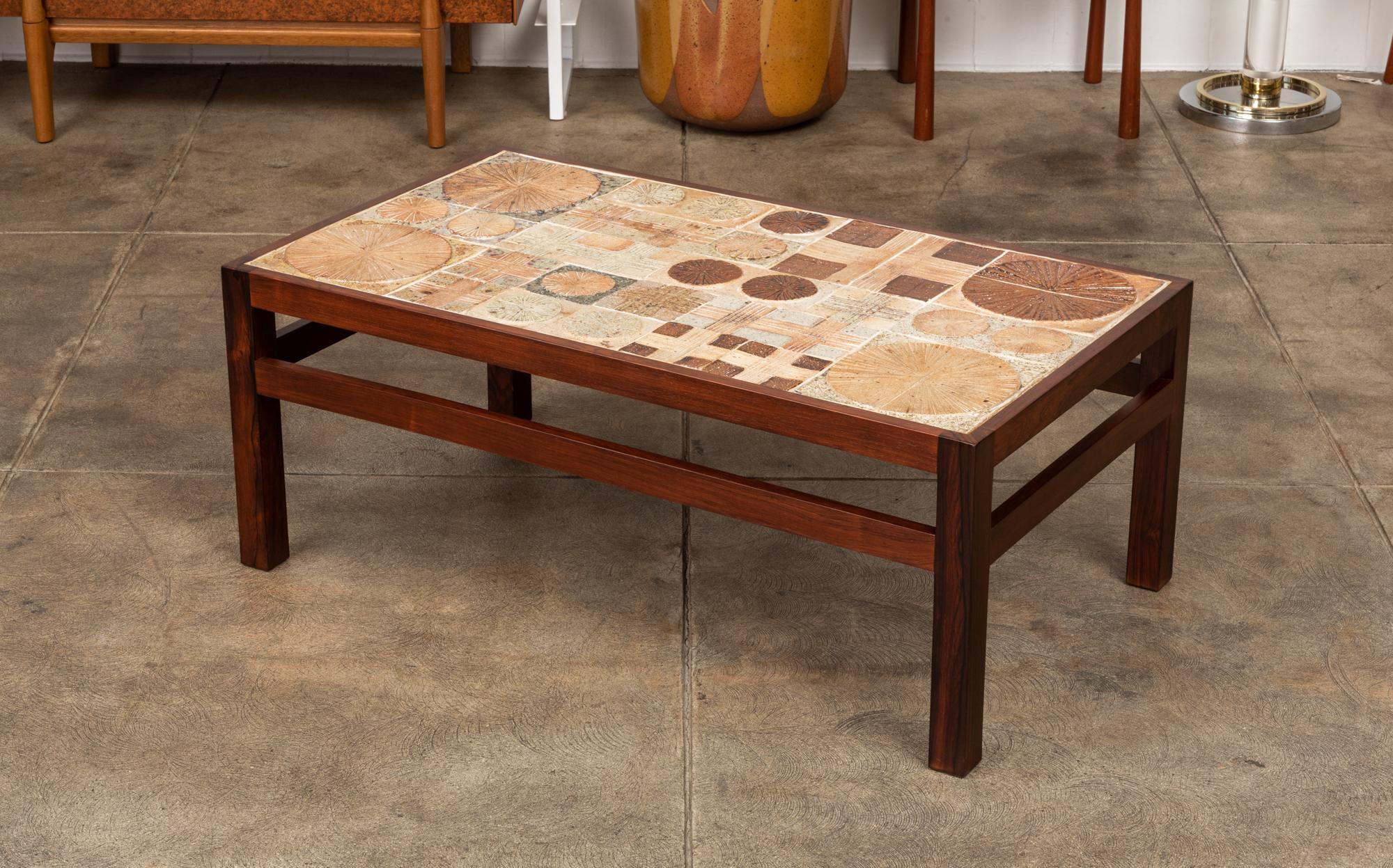 Tile topped coffee table designed by Tue Poulsen & Erik Wörtz in Denmark, for Illums Bolighus during the 1960s. The rectangular rosewood frame and square legs were designed by Wörtz and the ceramic tiles were created by artist Tue