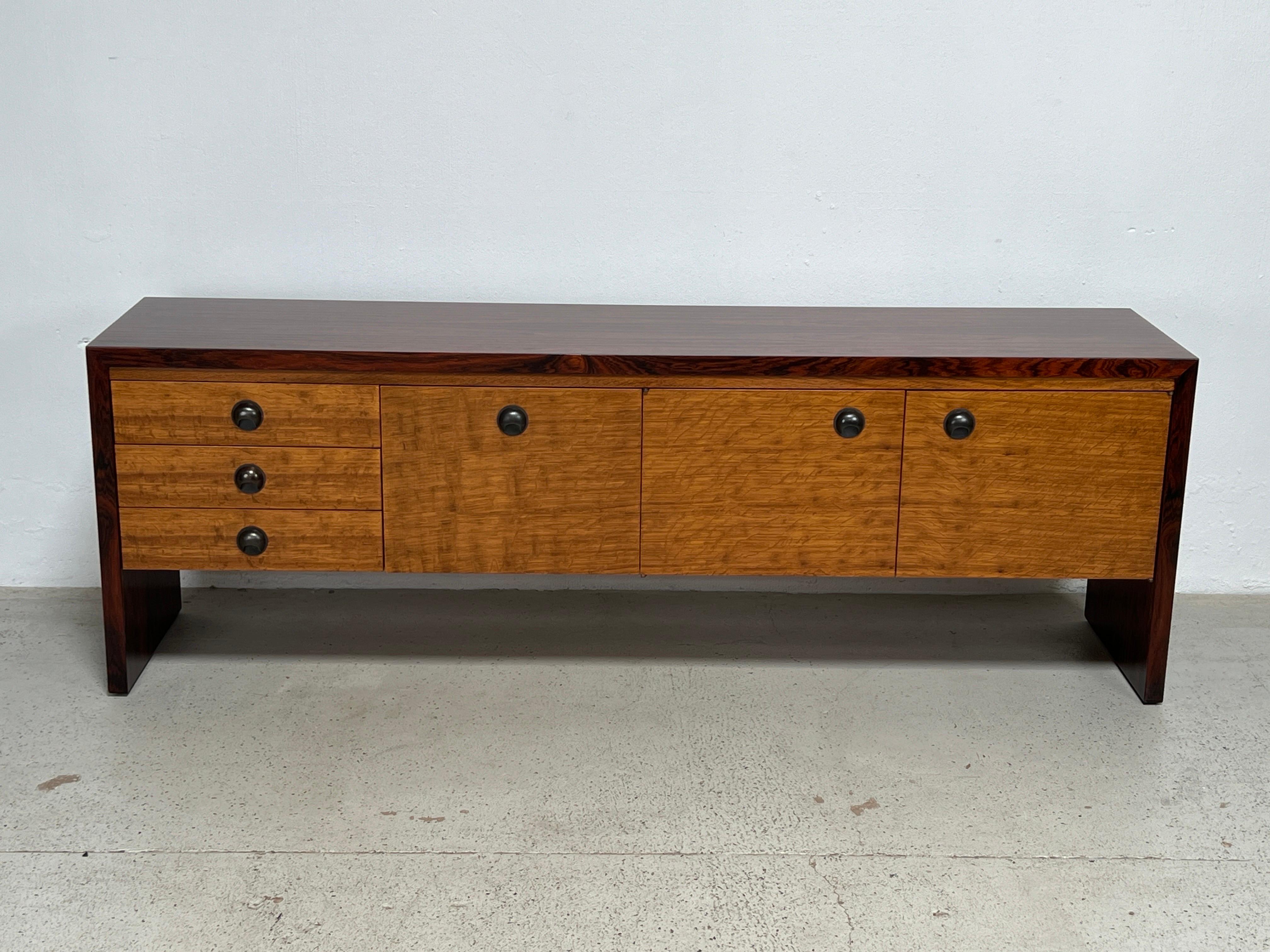 A rosewood and oak credenza with bronze hardware. Designed by Edward Wormley for Dunbar. Matching desk available separately. 