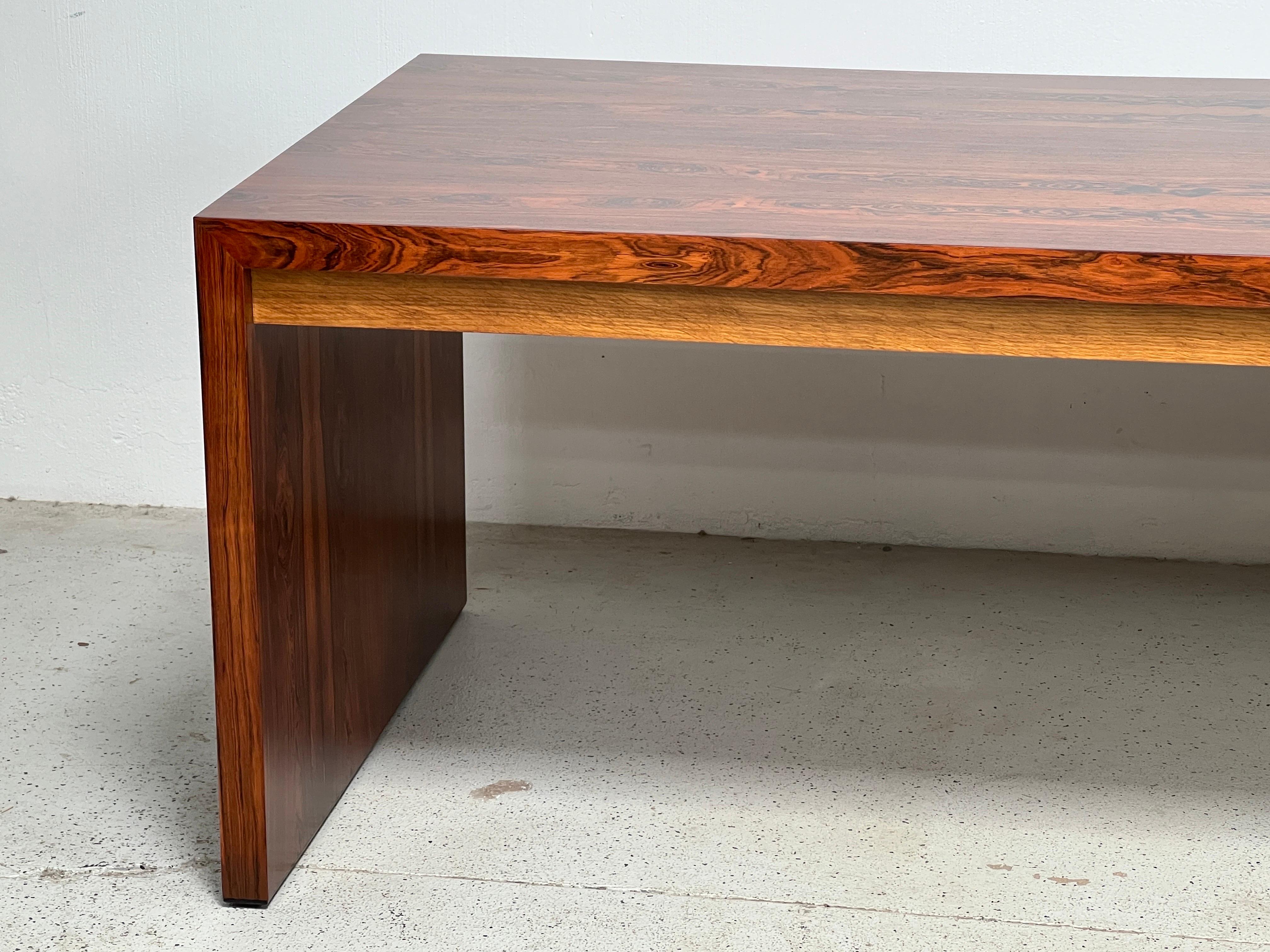 A large rosewood desk with oak drawers designed by Edward Wormley for Dunbar. Matching credenza available separately. 