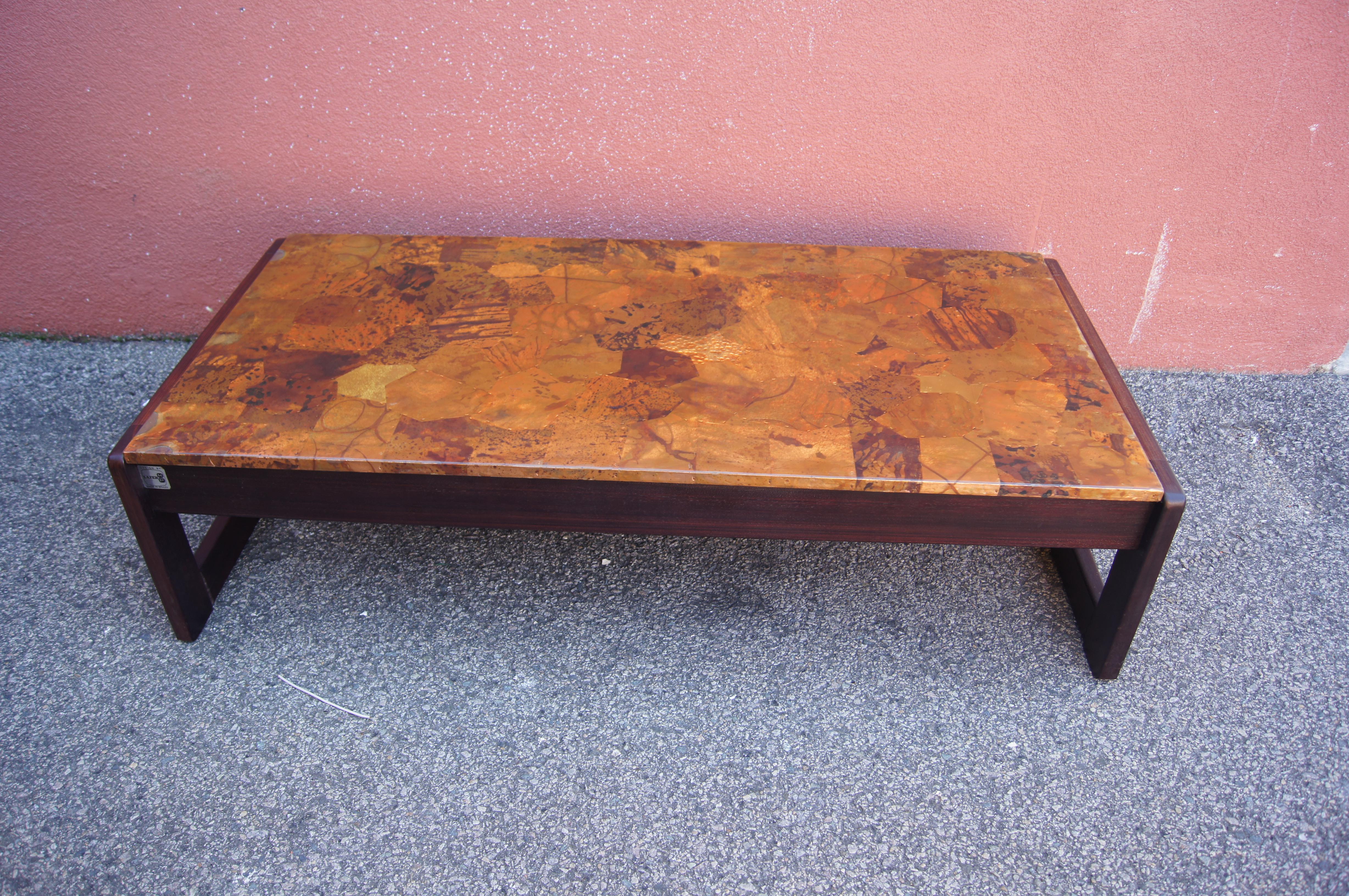 Conçue par le moderniste brésilien Percival Lafer, cette table basse en palissandre jacaranda présente un cadre rectangulaire audacieux avec des ferrures apparentes. La partie supérieure est fabriquée en cuivre patchwork magnifiquement patiné.