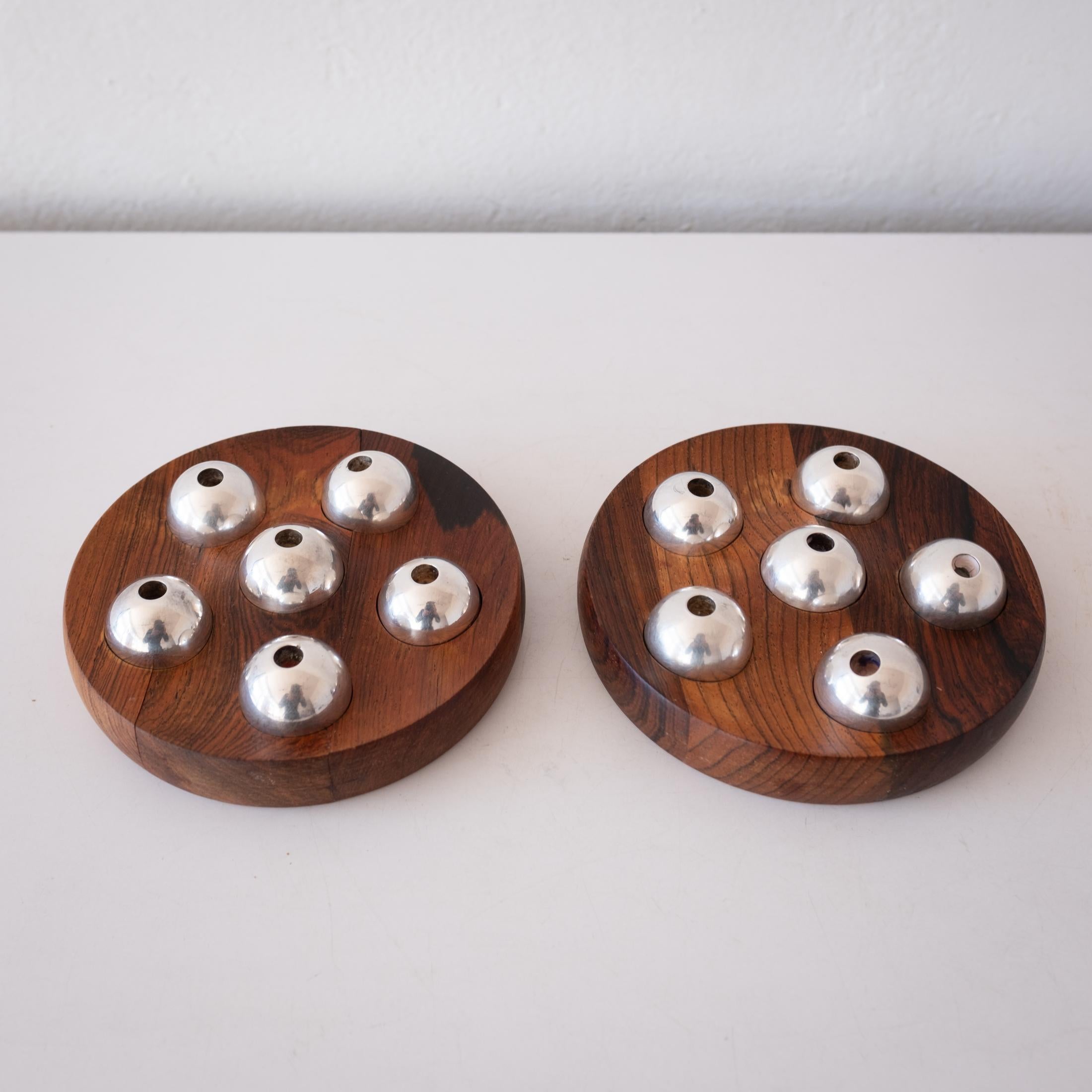 A rare pair of infinitely positional silver plate candle holders and carved rosewood bases. Options for two sizes of candles. Stamped on the back. Denmark, 1960s