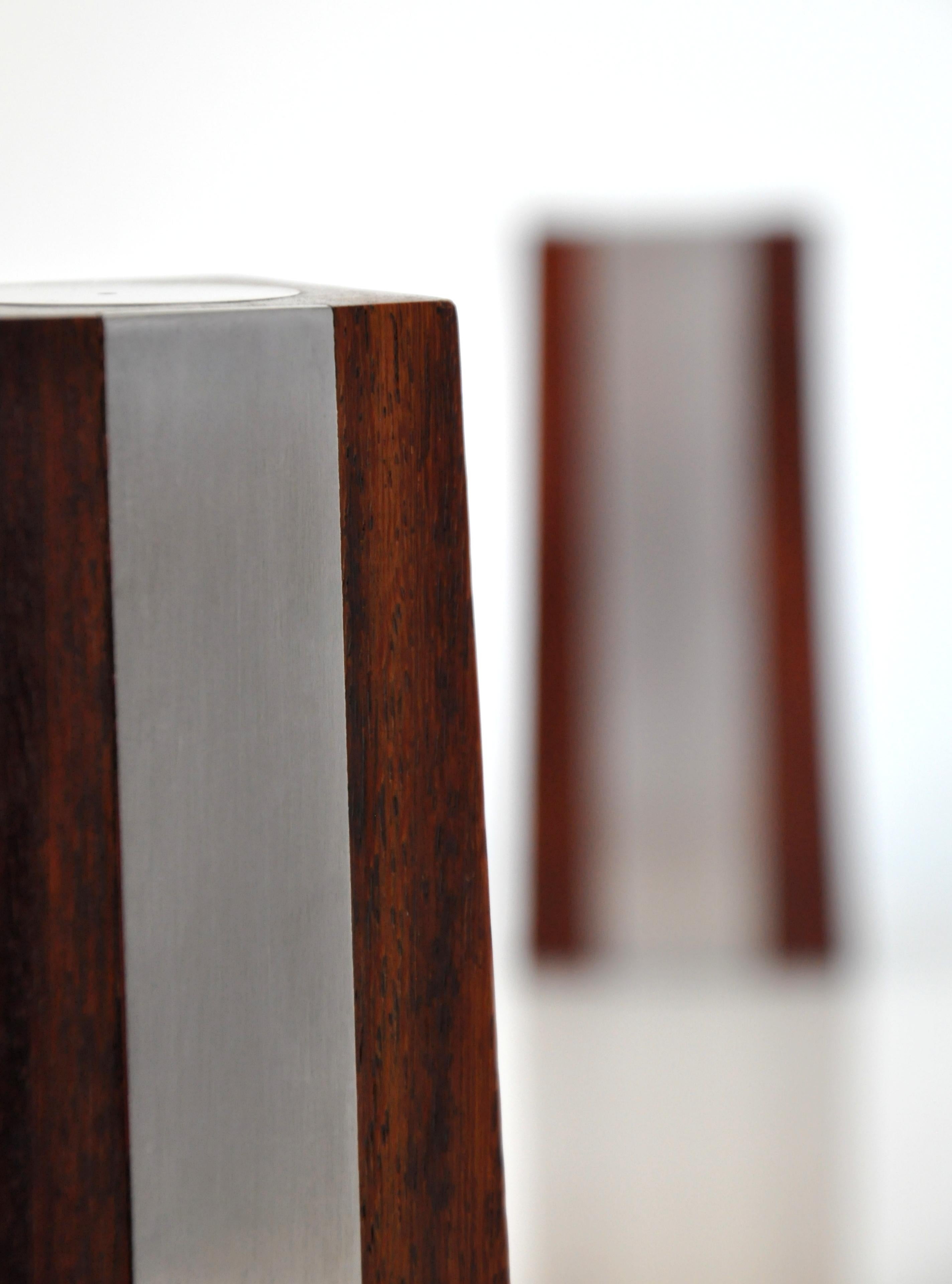 Vintage Danish obelisk shaped salt and pepper shakers. Rosewood with brushed steel accents, in the style of Paul Evans and Phillip Lloyd Powell.