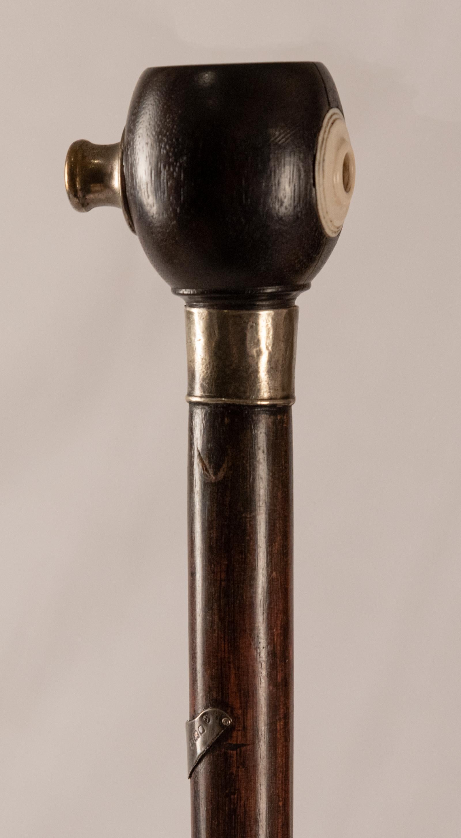 Rosewood and sterling walking stick with penny whistle, circa 1900

England

Measures: 35 x 2.5 x 2 in.