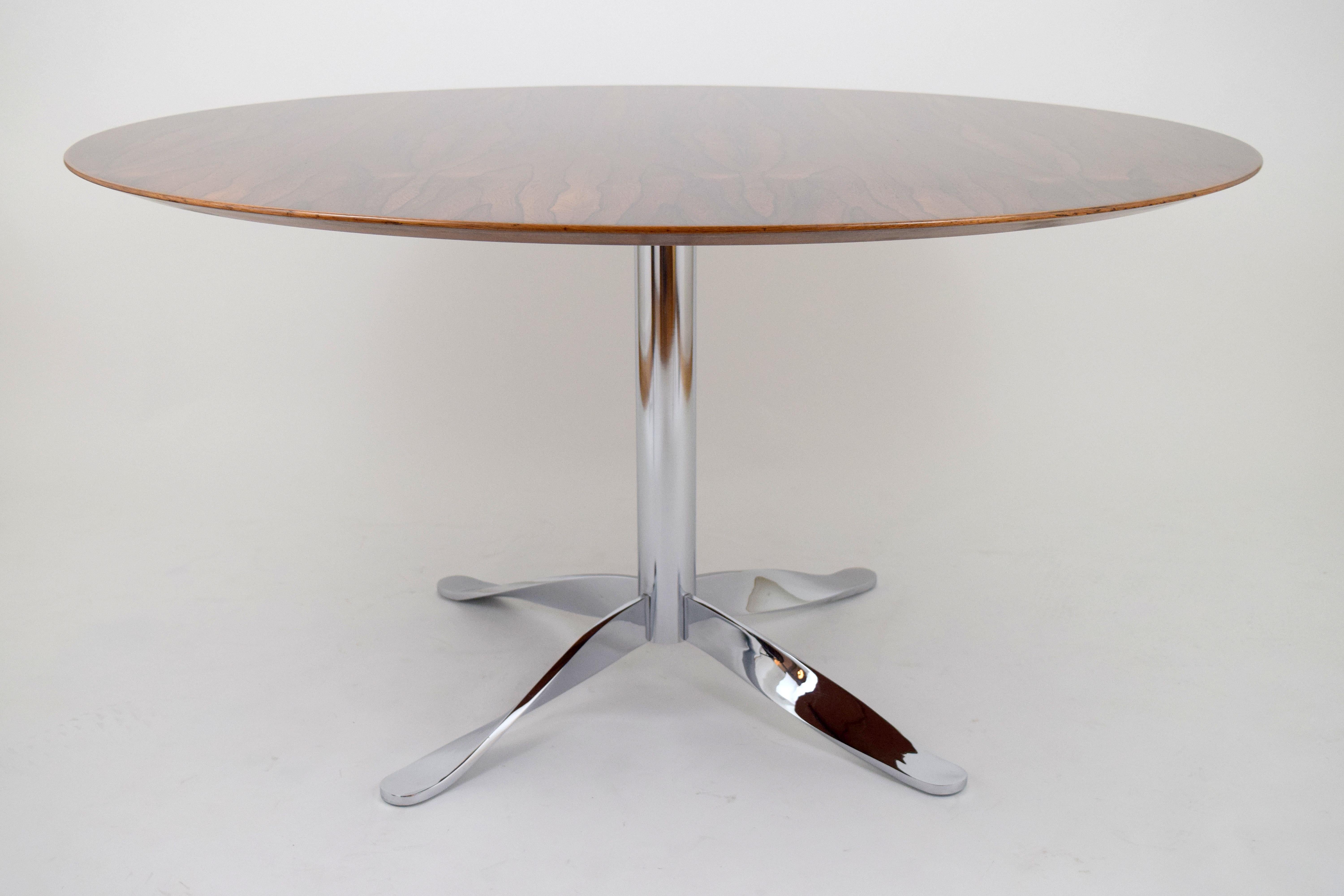 Stunning rosewood dining/conference table with unusual chrome twisted base. Gorgeous expressive grain to rosewood top with beveled edge detail. Supported by a polished chrome four-stared base with twisted legs. Very architectural and high quality