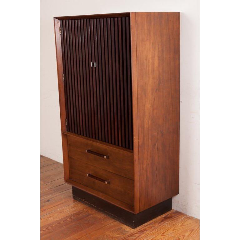 A classy and sophisticated 1960s American modern gentleman's highboy dresser by Altavista Lane. The rosewood doors feature a louvered design over two drawers with chrome handles. Inside the upper cabinet is two pull out drawers with interior cabinet