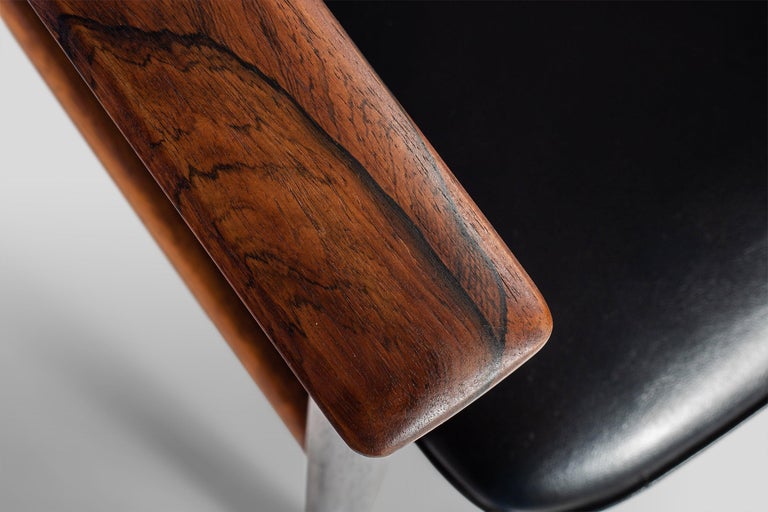 Hardwood rosewood frame and vinyl armchair designed by Sven Ivar Dysthe in Norway for Dokka Mobler in the 1960s. This chair is in very good condition minus some small cat scratches on the top of chair back. Upholstery services are offered at an