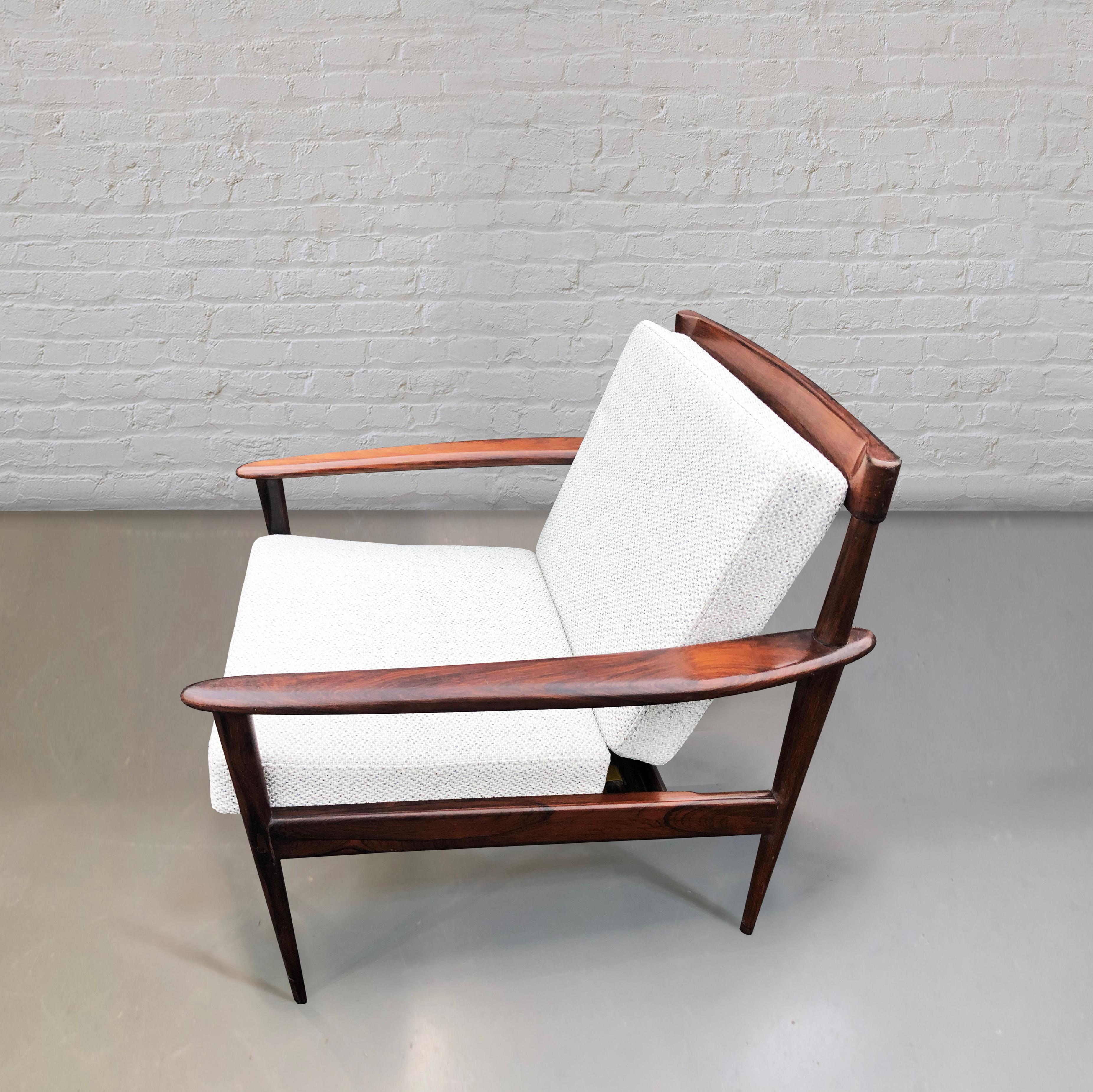 Solid wood armchair and ottoman, by Rino Levi. 
Brazil, 1960s
Manufactured by Móveis Ambiente. 

A perfectly balanced armchair, masterly executed. Stunning minimal back rest made of four sleek solid wood  slats.
The fluid tapered legs and slim
