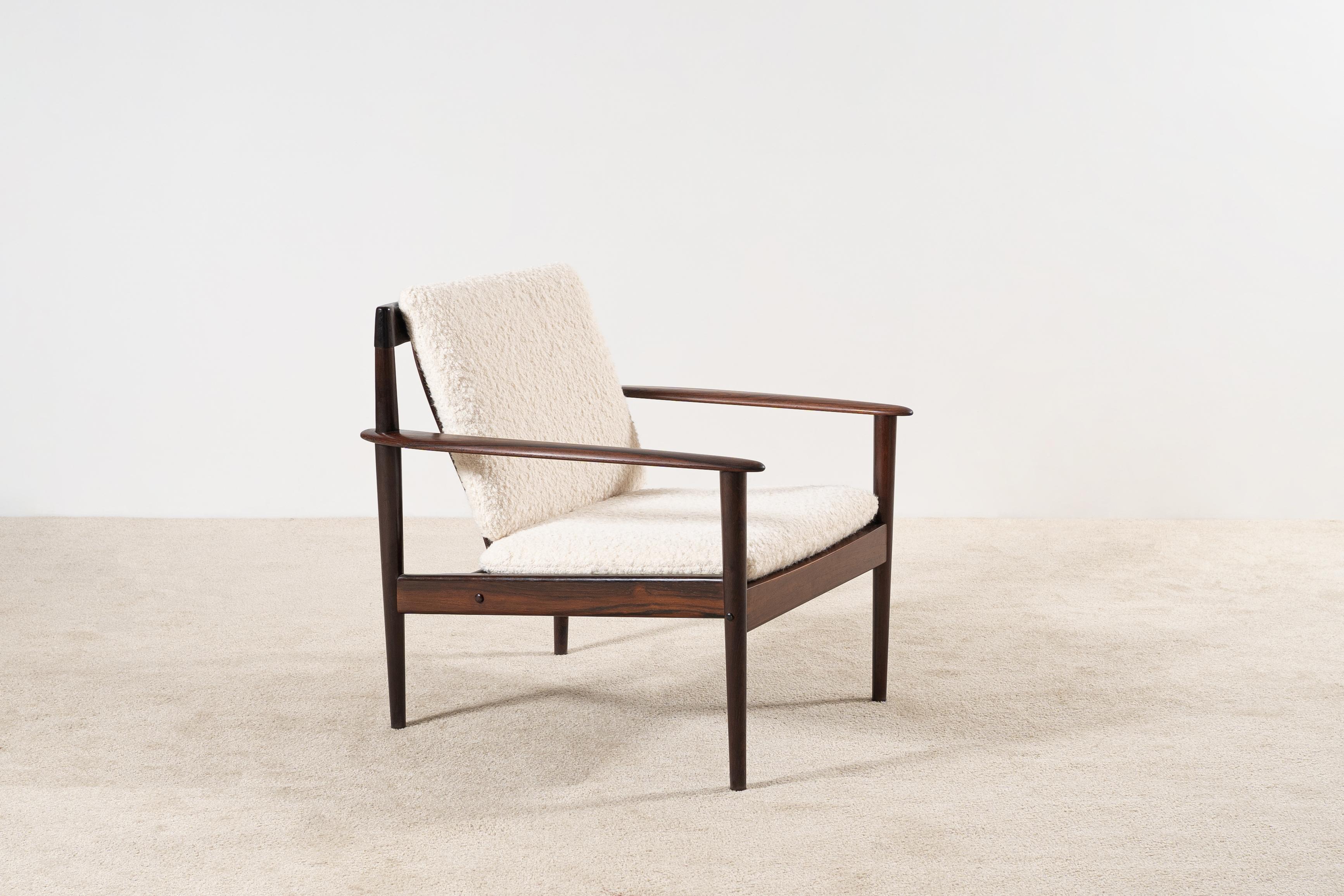 Rare armchair model 56 designed by Grete Jalk and produced by P. Jeppesens Møbelfabrik in Denmark. Circa 1960. 
Rosewood structure and newly upholstered in the traditional way by the best French craftsmen with a Nobilis wool Bouclé fabric.
This