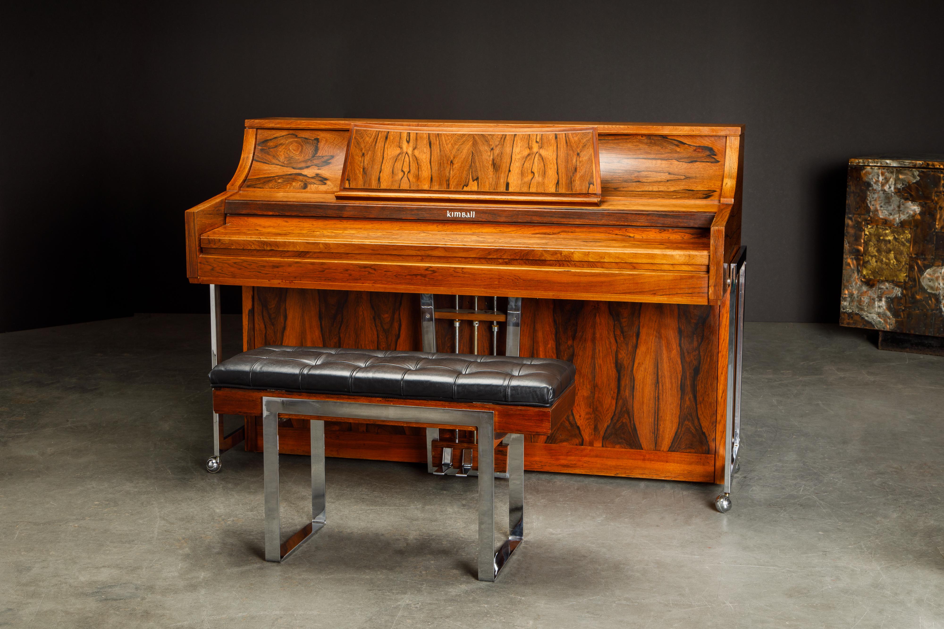 This incredible Rosewood piano is by Kimball, circa 1960s, and called the 'Artist Spinet' piano. We believe is the most attractive Mid-Century Modern piano we have seen, the Rosewood throughout the piano has gorgeous wood grain and color. Excellent