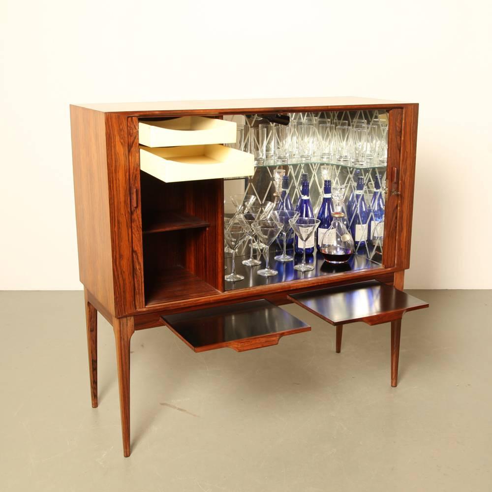 name: bar cabinet
designer: Kurt Østervig
manufacturer: K P Møbler, Denmark
design year: 1960s

with tambour doors and dual pull out drink preparation slates.