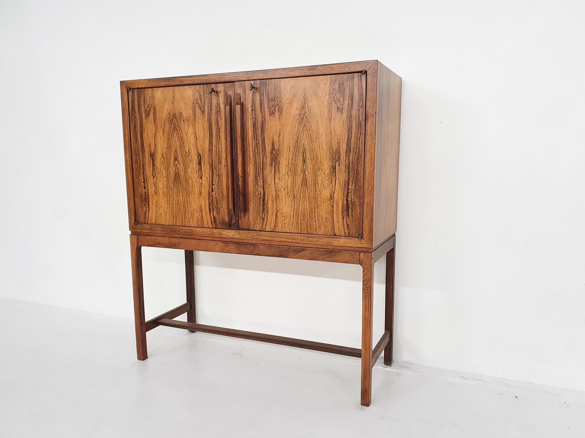 Super high quality and elegant bar cabinet or dry bar in rosewood by Torbjørn Afdal for Mellemstrands Møbelfabrik.

This item is true Scandinavian high end furniture. It is made of the most beautiful rosewood and has nice brass details. Inside the