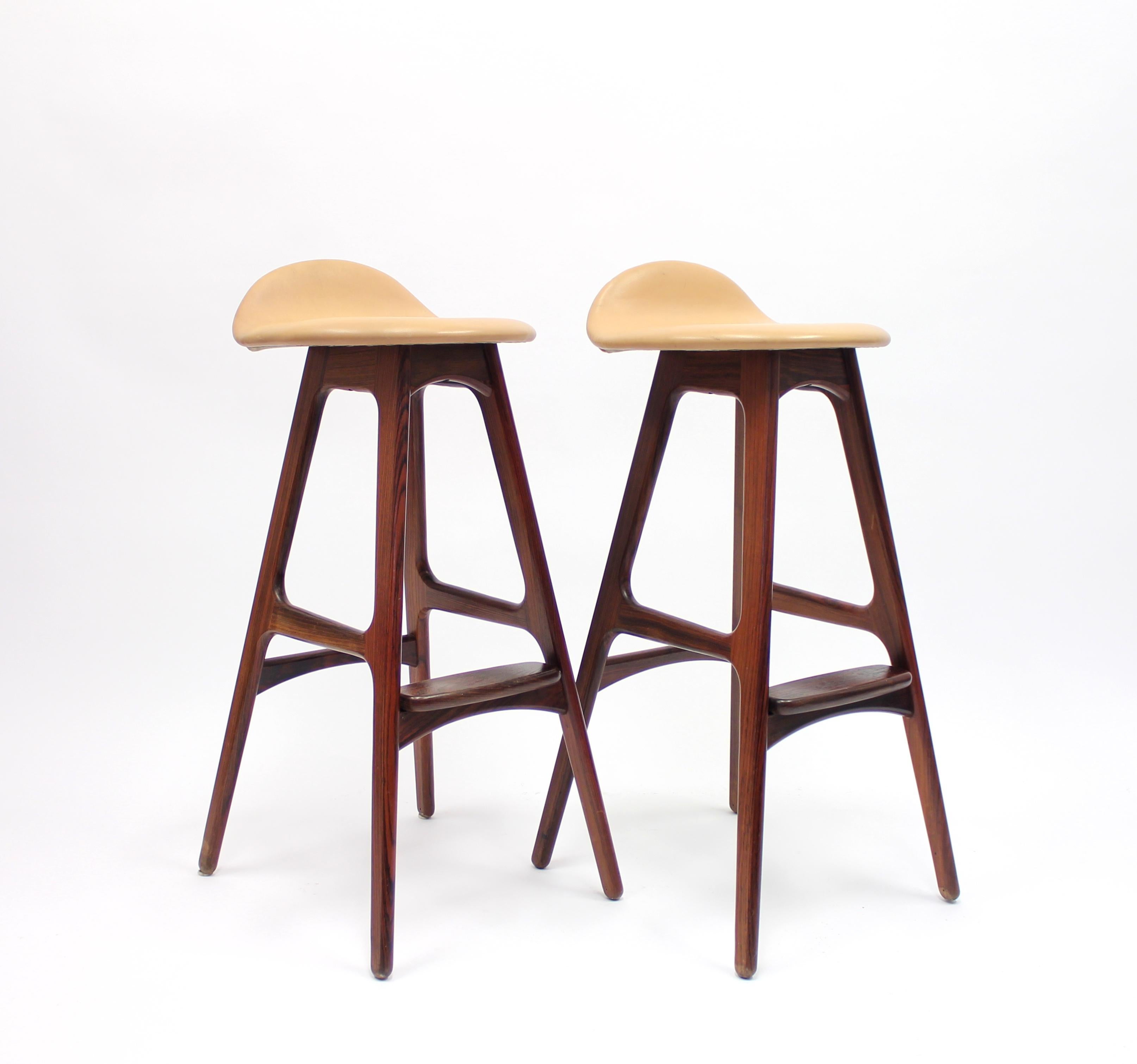 Pair of rosewood and leather barstools, model OD61, by Erik Buch for Oddense Maskinsnedkeri A-S, designed and produced in the 1960s. Both chairs are labeled by the maker. All original condition with light ware consistent with age and use.