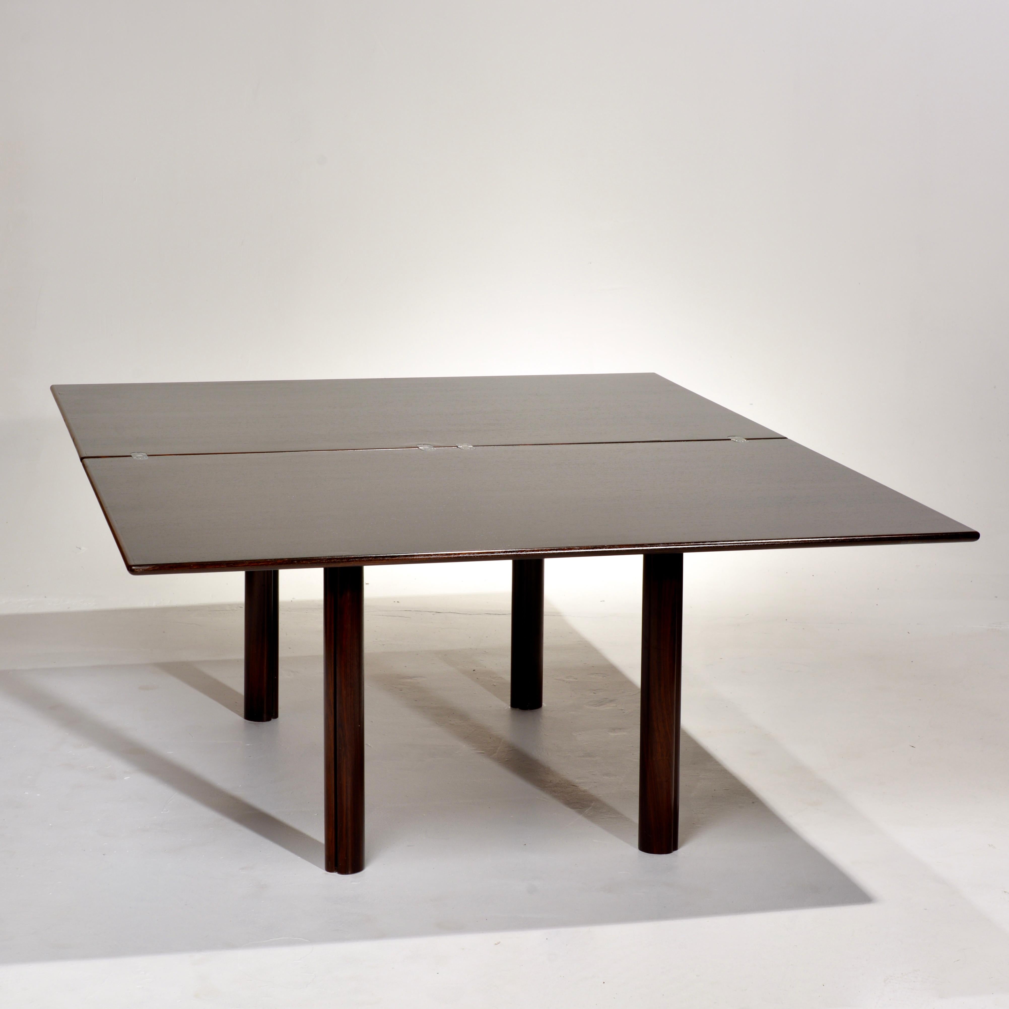 This is an amazing and rare rosewood bi-folding dining table designed and made in Denmark, c1975.