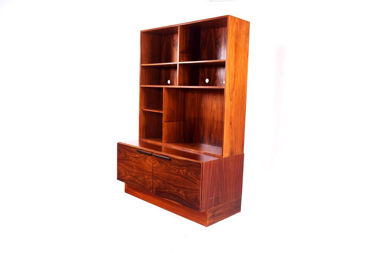 Bookcase by Ib Kofod-Larsen for Faarup Mobelfabric in rosewood. Danish Mid-Century Modern, 1960s. Square rosewood cases, with shelves and a double-door cabinet. It has a secondary add-up module with shelves, sometimes used separately fixed on a