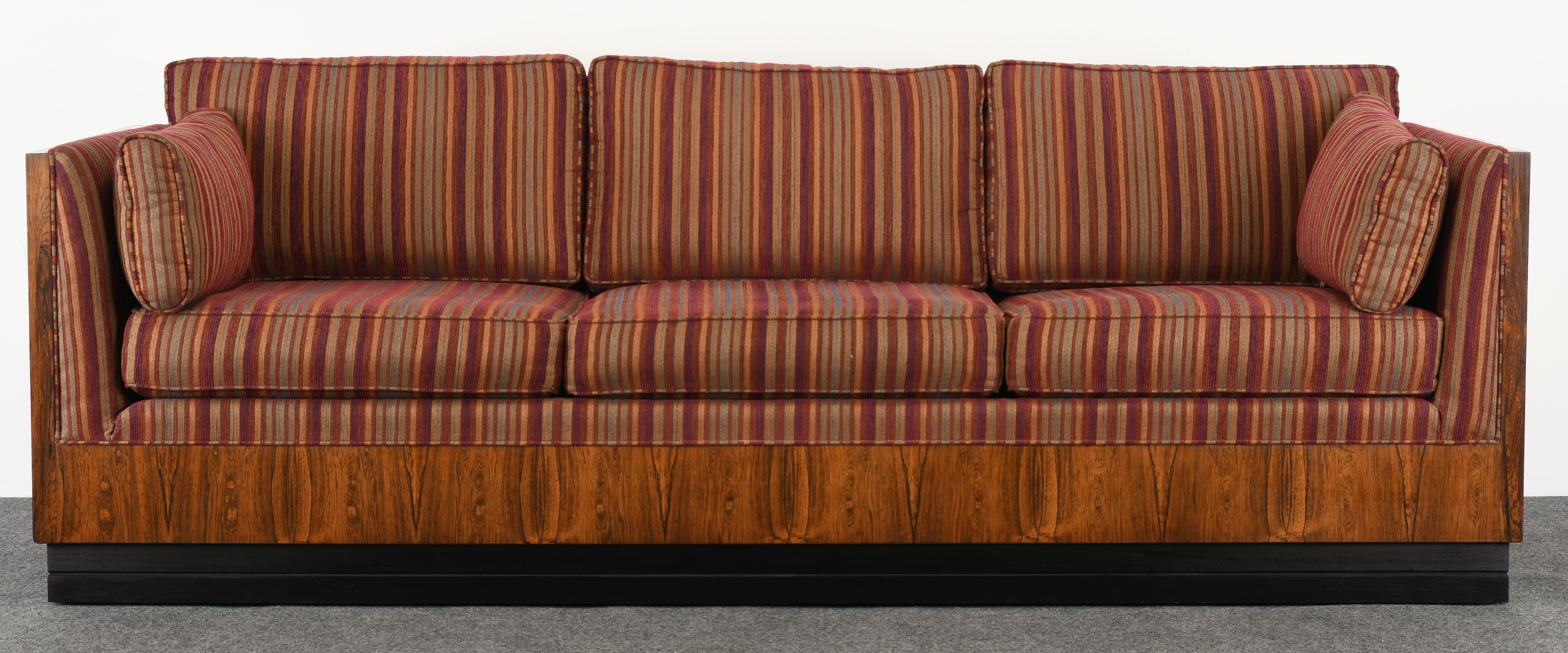 An elegant Mid-Century Modern rosewood tuxedo sofa designed by Milo Baughman for Thayer Coggin. This modern sofa would work in any modern or contemporary interior. The classic design has simple sophistication with the rosewood side and back case.