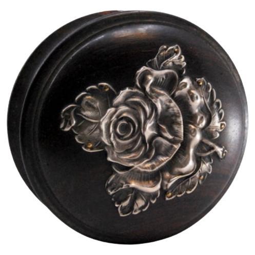 Rosewood box with silver application on the lid in the shape of a flower