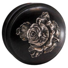 Rosewood box with silver application on the lid in the shape of a flower