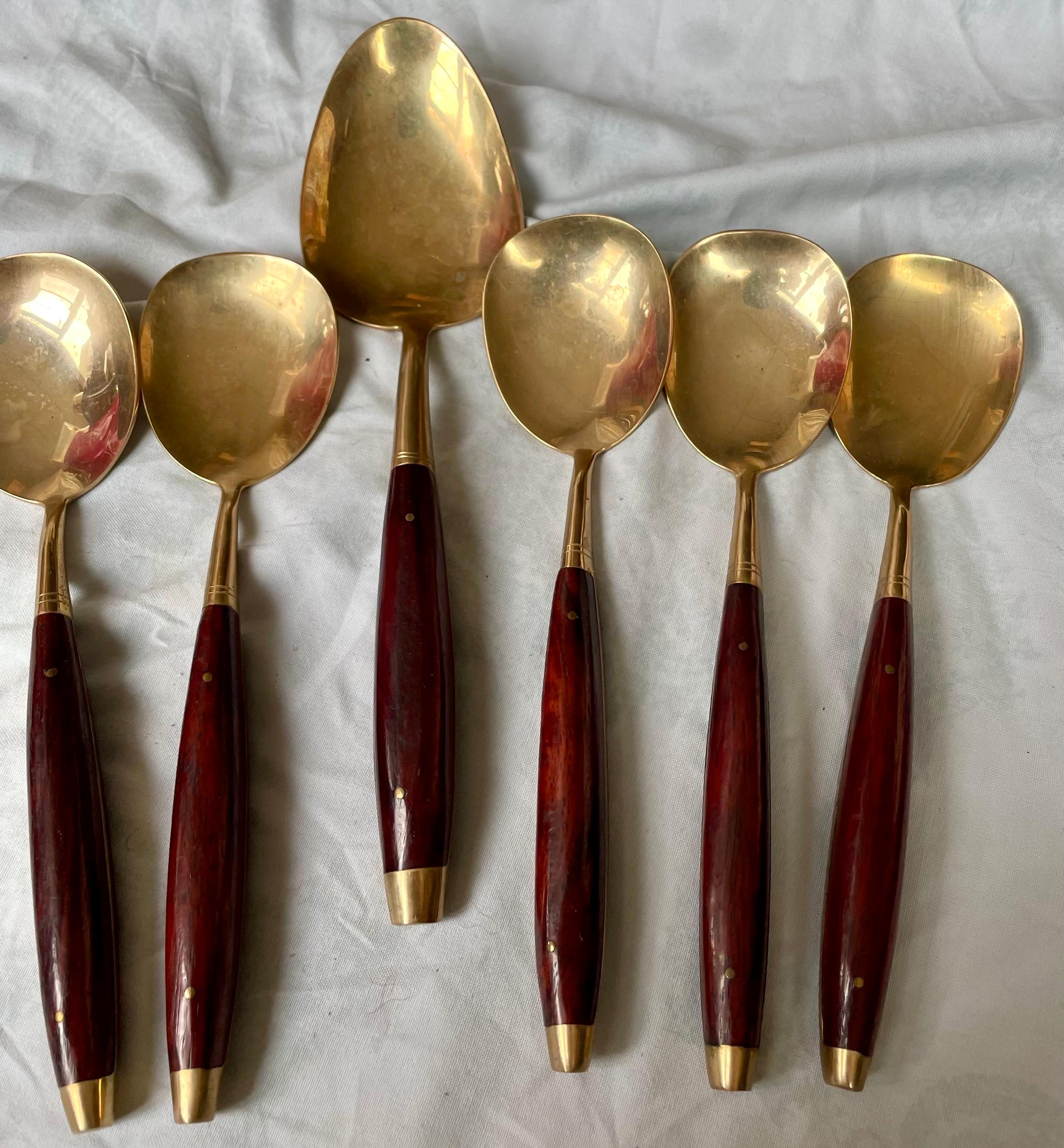 This is a great looking set of brass shaped spoons, one large and 5 matching smaller spoons with rosewood handles, that will be perfect for soup or desert (perhaps ice cream) they also can all be used as serving spoons. They will be a wonderful