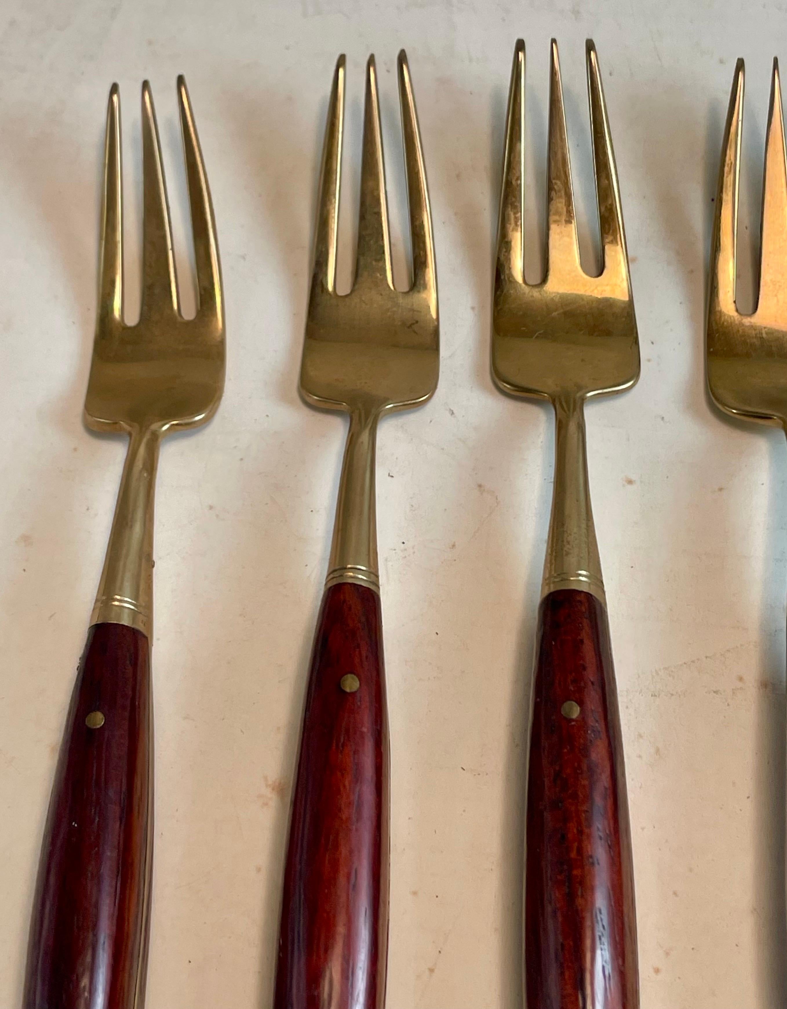 This is a very sweet set of small (5 inch) forks made of brass with rosewood handles that will be perfect for delicate deserts or h'orderves and will make a special addition to your holiday table. They are in good condition with only the expected
