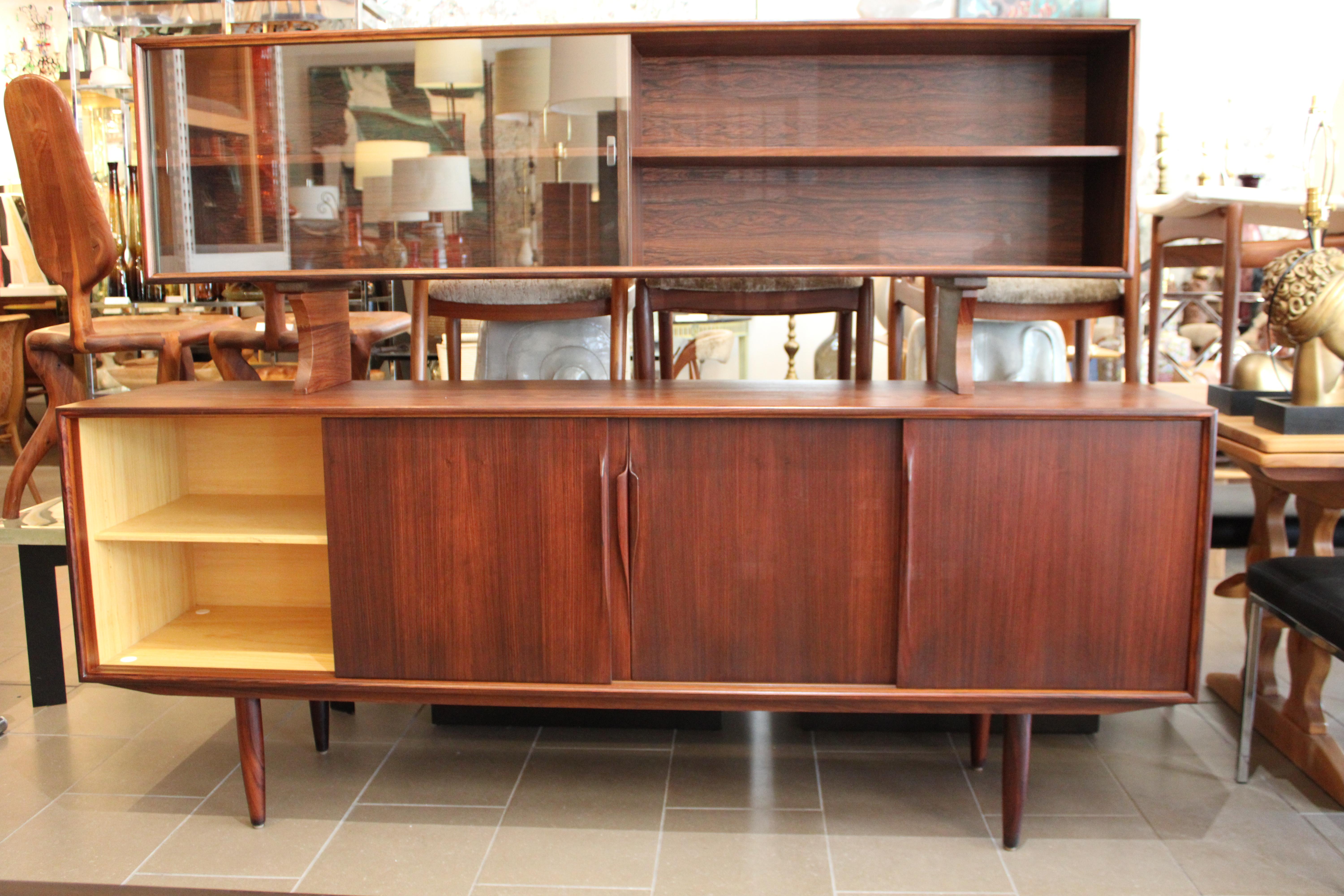 Vintage buffet sideboard by Axel Christensen for ACO Møbler, Denmark 1960s. Beautifully designed sideboard in rosewood with elegant handles, three drawers and plenty of storage space with adjustable shelves. The sideboard (top portion) is marked by