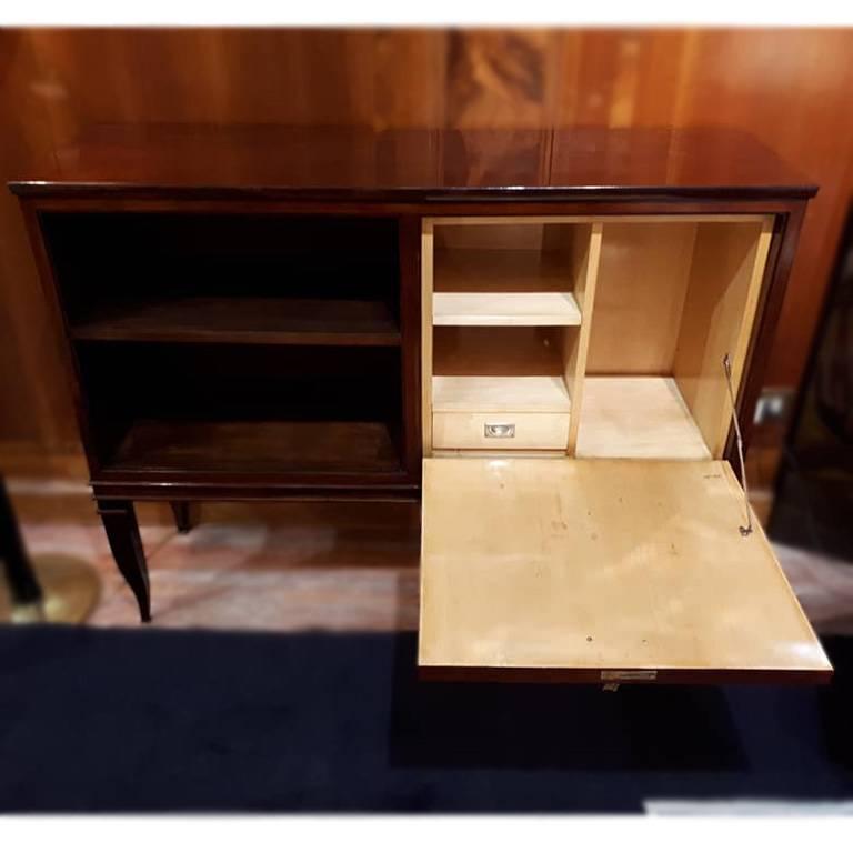 Great rosewood cabinet by Gio Ponti. It has a door and open compartment with a shelf; the details are made in bronze and brass. Dimensions: cm 121.5cm x 37cm, height 95cm, Italy, 1925.
