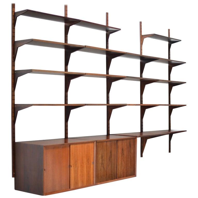 Highly versatile and functional Cado System wall unit in Brazilian rosewood by Danish designer Poul Cadovius. Wall unit can be customized with varying cabinets and shelving.