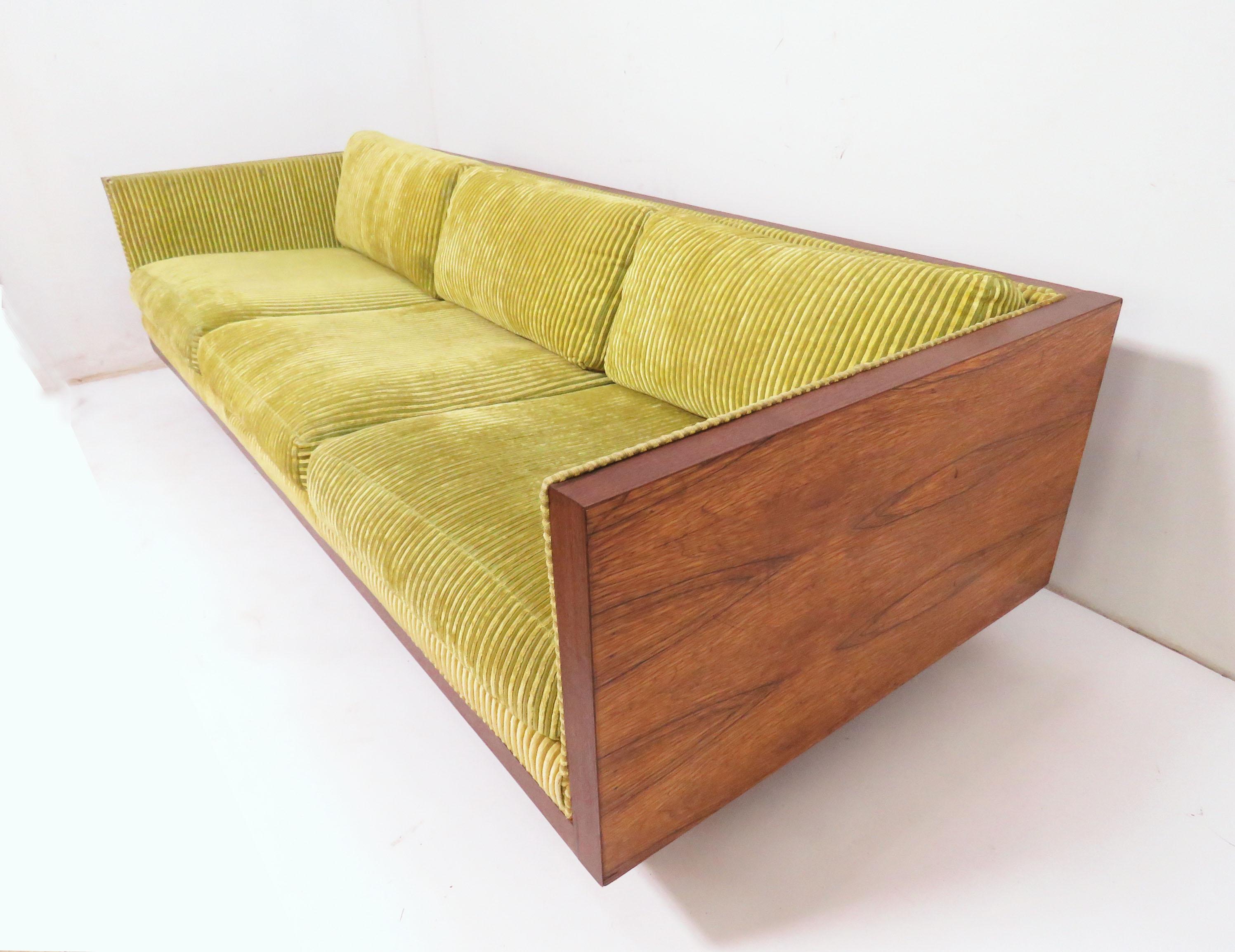 Tuxedo style three-seat sofa in a rosewood cased frame, in the manner of Milo Baughman, circa 1970s. By Charlton Furniture, USA, imported from Israel.

Case measures 85.75