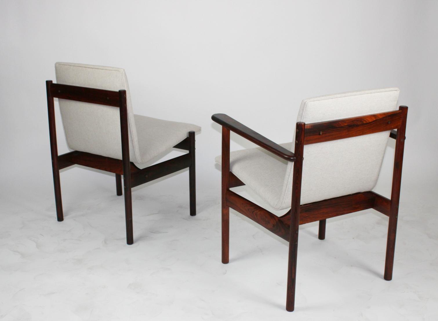 Stunning rosewood chairs with scoop seating newly upholstered in cream color cotton.
Set includes 2 captain chairs and 2 sides. circa 1960s.
Sold as a set of 4.