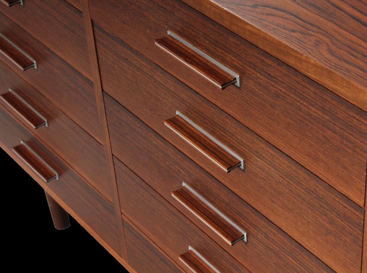 A very good quality chest the bottom two drawers are in the form of 4 drawers so it is in fact 8 drawers, all with rosewood and aluminum handles, a style favoured by the designer, Axel Christiansen.