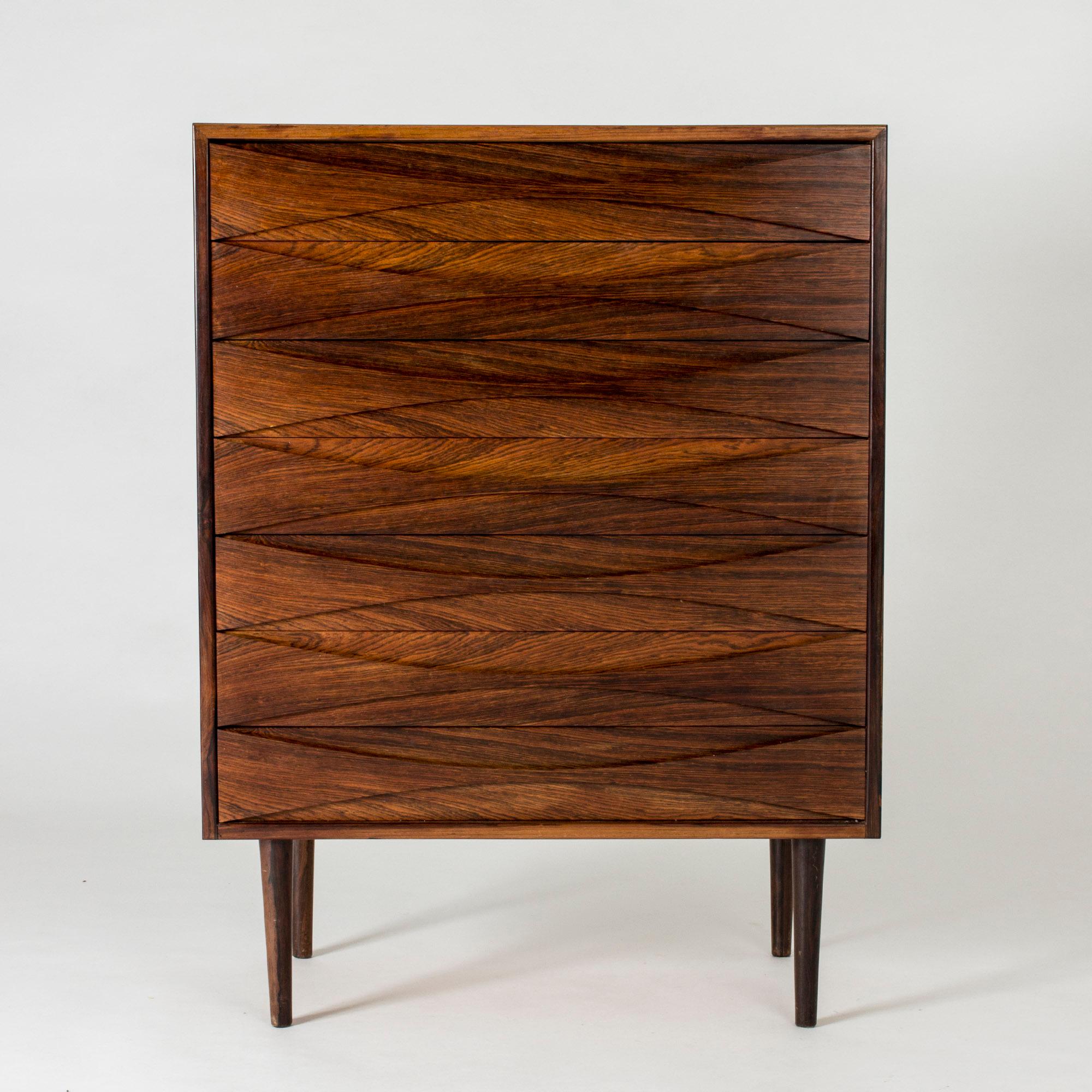 Rosewood chest of drawers by Arne Vodder, where the fronts of the drawers form a striking design. Amazing play between the curved lines and pattern of the wood grain. Professional repair on the top.