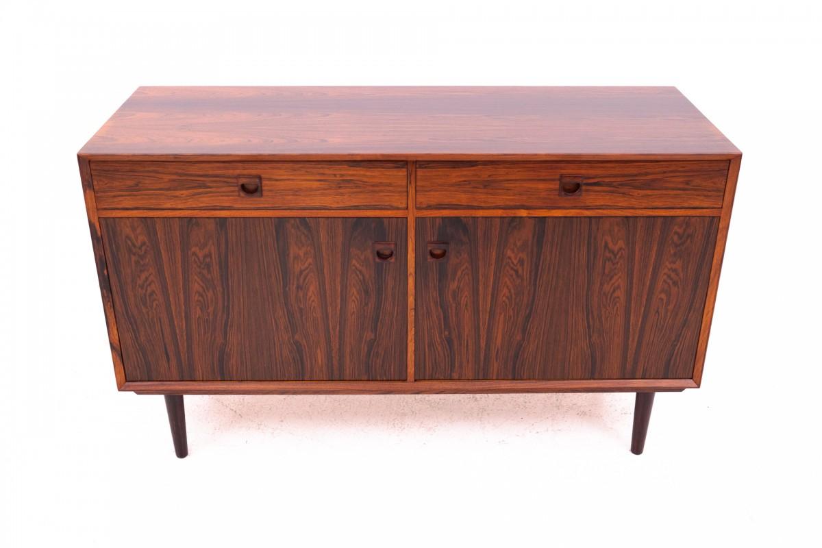 Rosewood chest of drawers, Denmark, 1960s.

The chest of drawers has two external drawers, one of which is closed with a sliding top. Behind the double doors there are two capacious spaces, each with one shelf.

Minimalist, timeless design will work