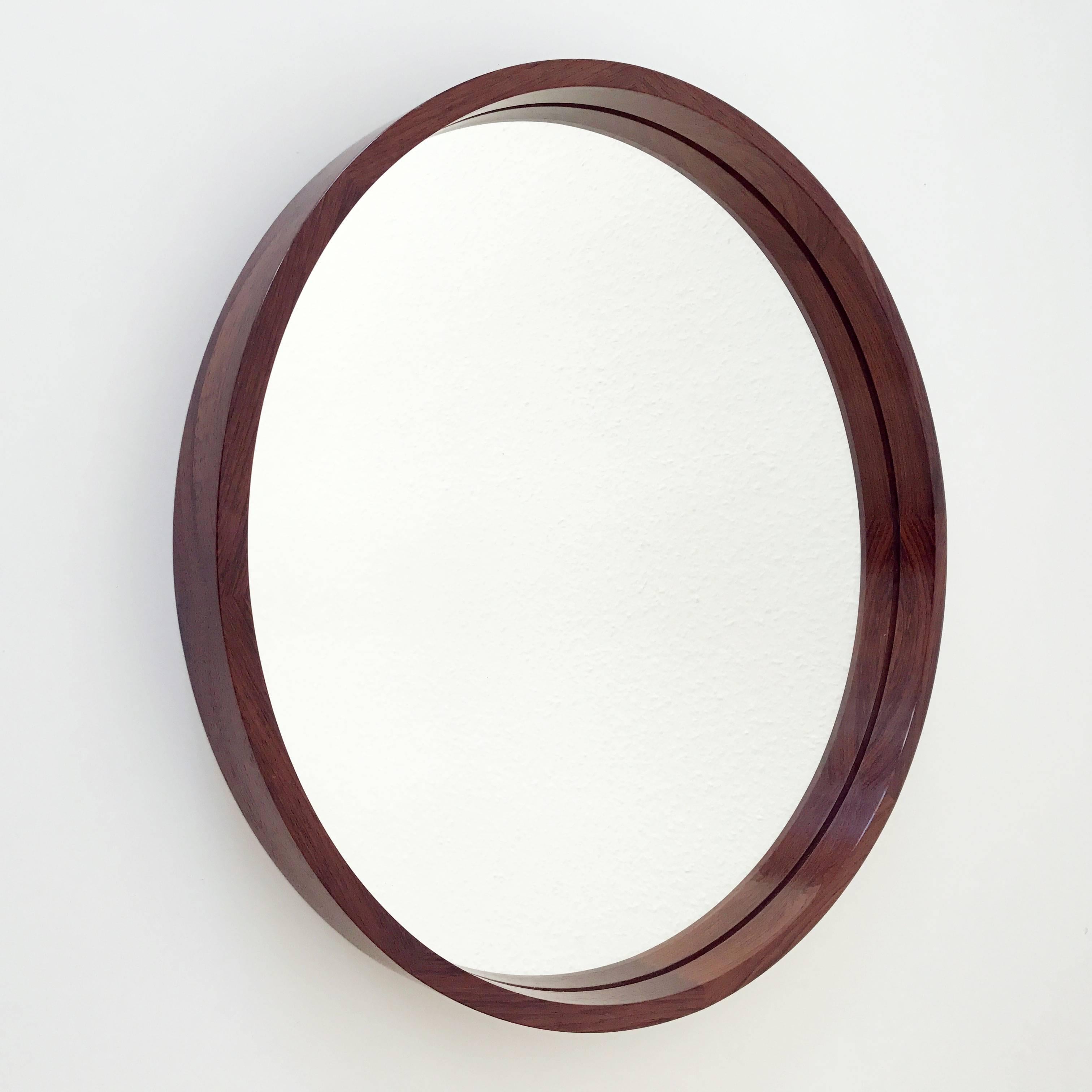 Elegant circular wall mirror. Executed in rosewood by Th. Poss' Eftf Copenhagen, Denmark in 1960s.
