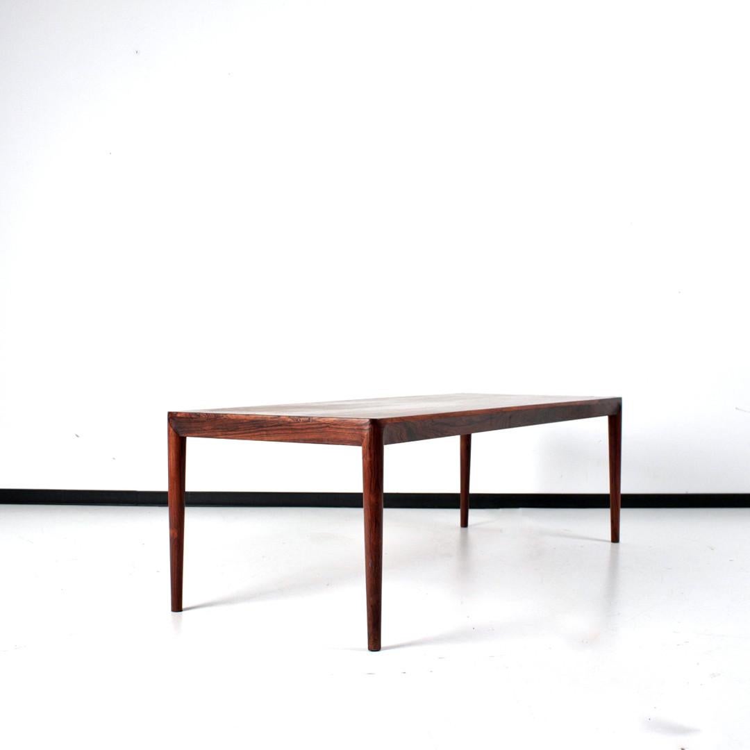 Danish design coffee table from the 1960s. Design by Erik Riisager Hansen for Haslev Møbelsnedkeri. Made in veneered Rosewood. The quality of the craftmansship, the slightly organic details and the finishing of the legs live up to the highest