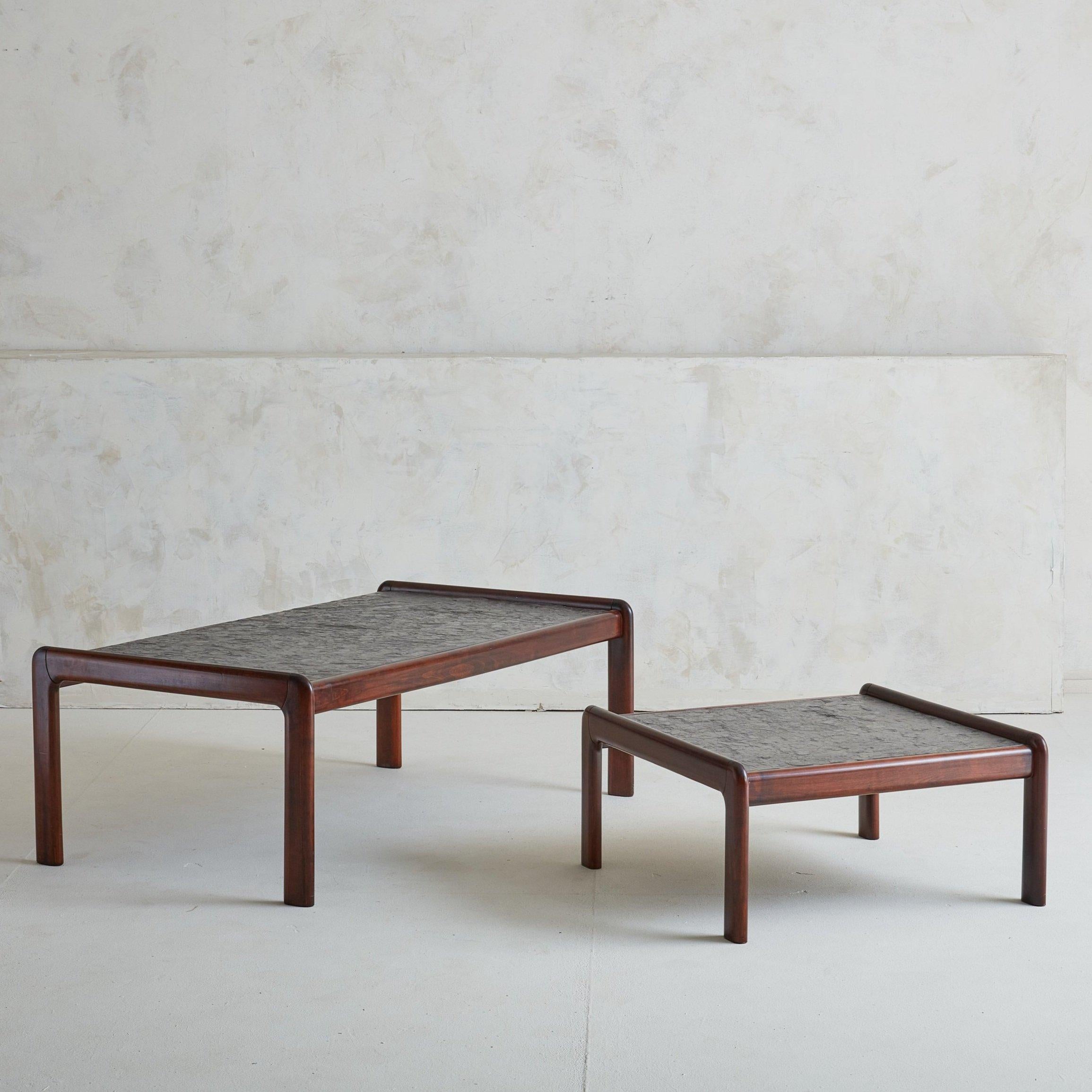 A 1980s French coffee + side table featuring beautifully grained rosewood frames with inlaid textured stone tops. The gentle curve of the frame-legs show excellent craftsmanship and are reminiscent of the classic lines of bentwood, a typical Mid