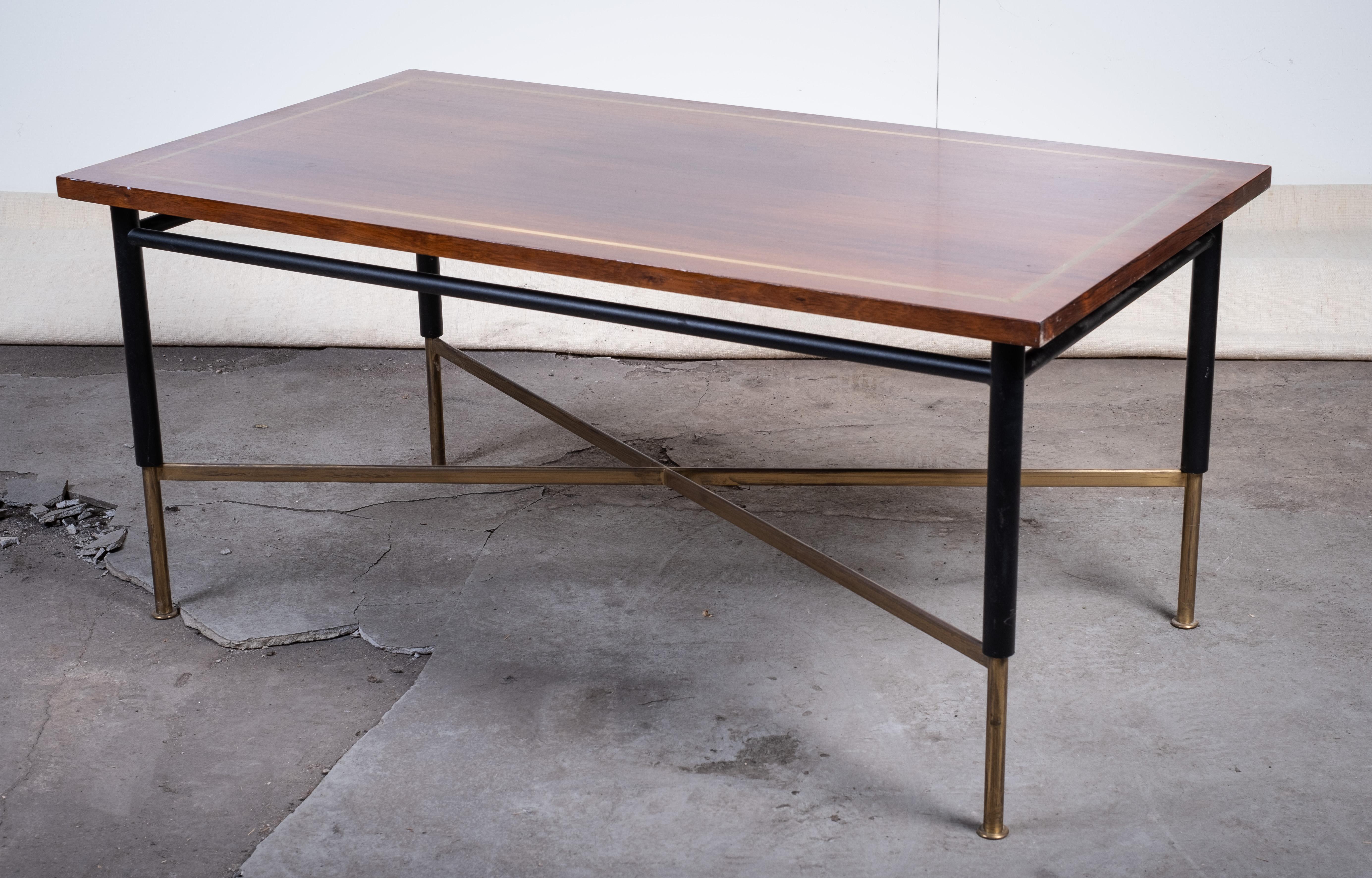 Coffee table designed by Ernst Kühn in the 1950s. Crafted in rosewood with brass inlays and a sleek metal base. The combination of fine materials and clean lines reflects the sophisticated aesthetics of Danish mid-century design.

A rare and