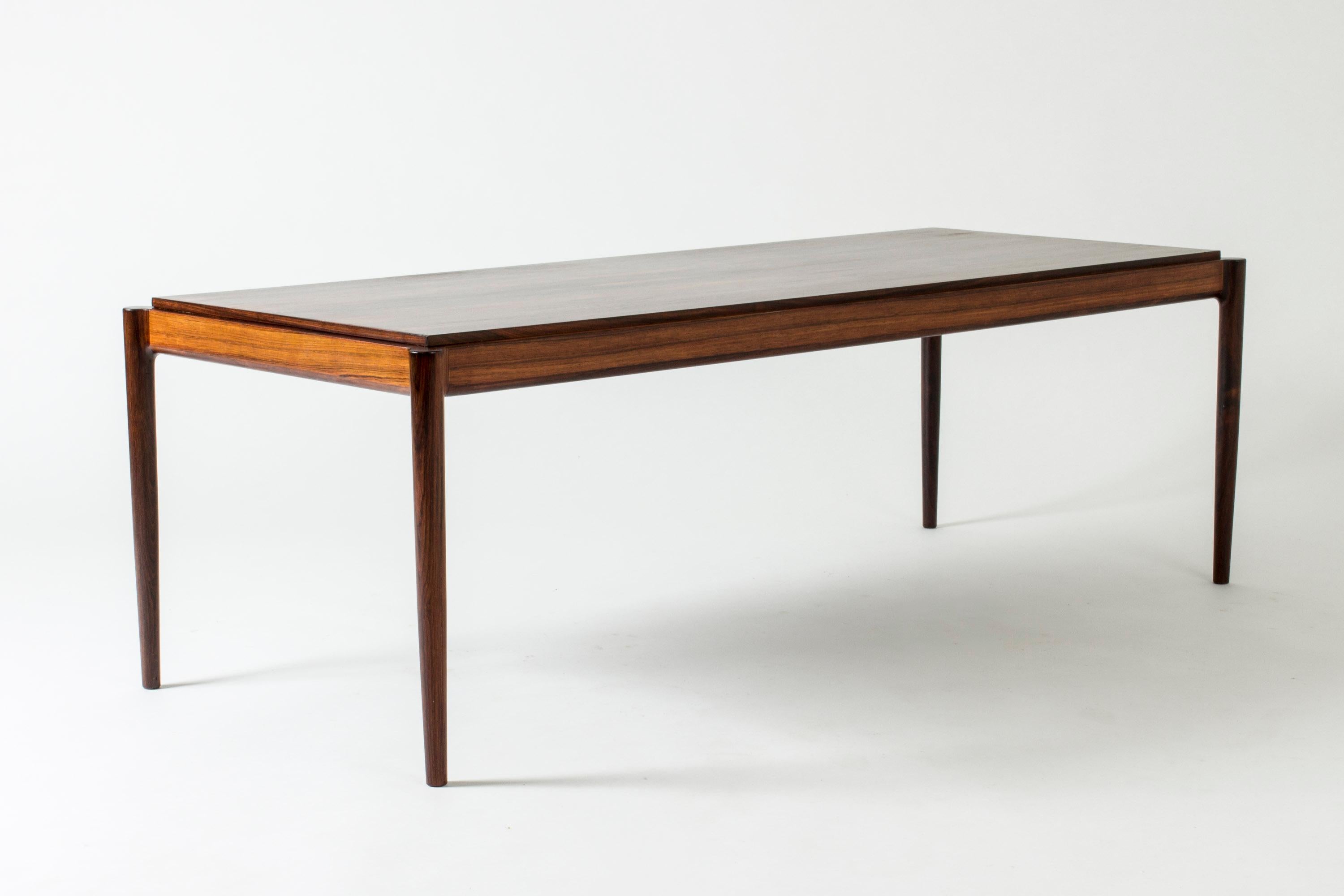 Coffee table with cool attachment of the legs to the table top by Ib Kofod Larsen, made in beautiful rosewood.