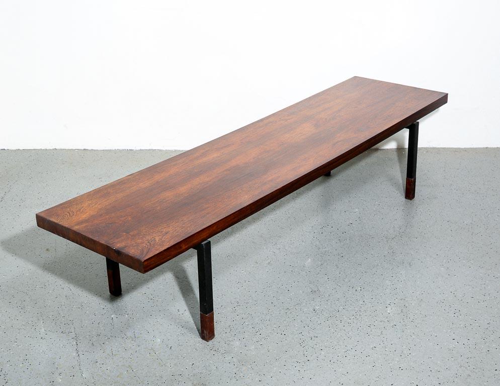 Mid-20th century coffee table with rosewood veneered top and steel base with solid rosewood tips. Designed by Johannes Aasbjerg. Signed. Has slight bowing to top.