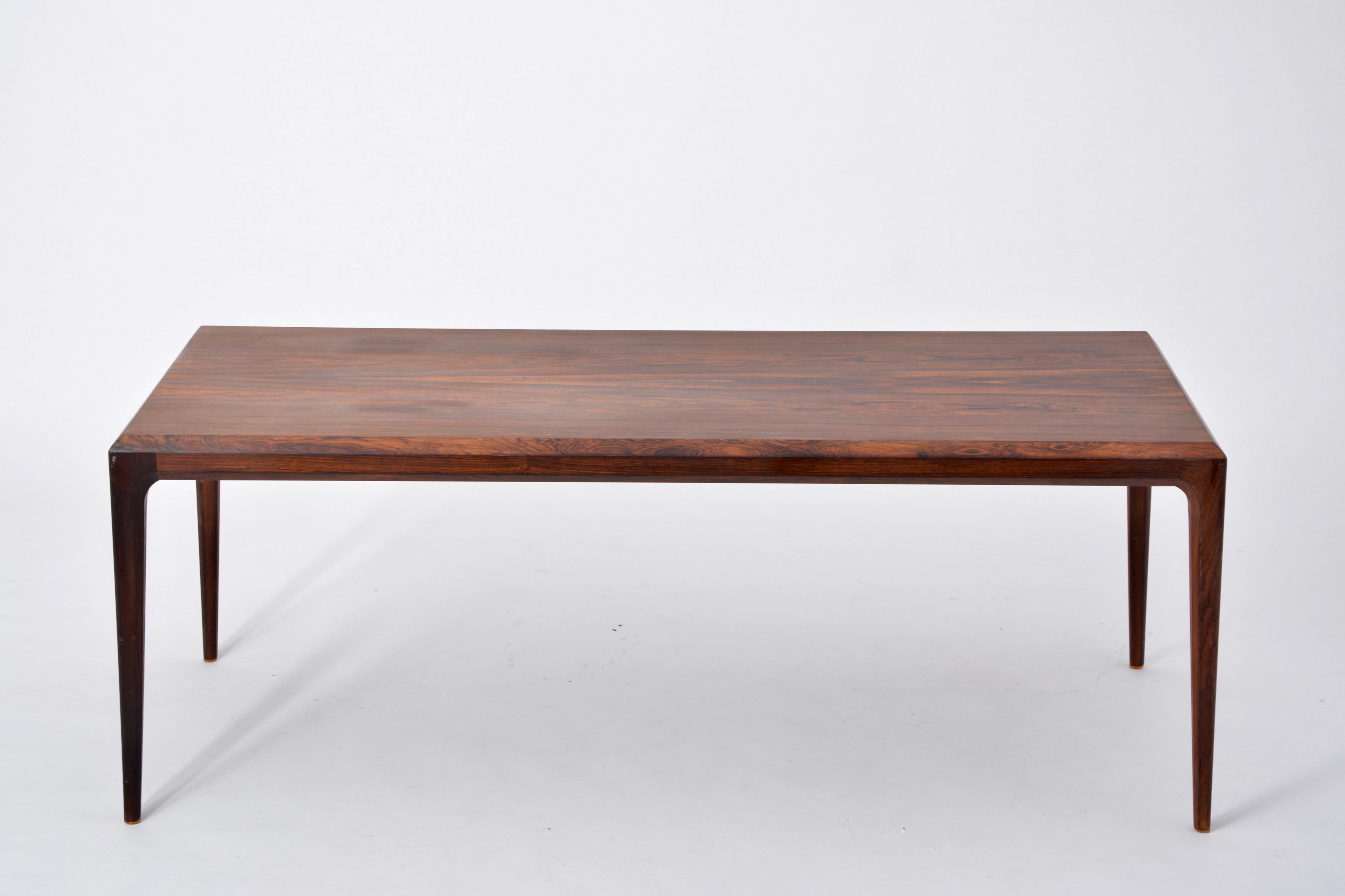 Rosewood coffee table designed by Johannes Andersen and produced by CFC Silkeborg, Denmark in the 1960s. The table had some small chips on the edges which have been repaired (see photos).