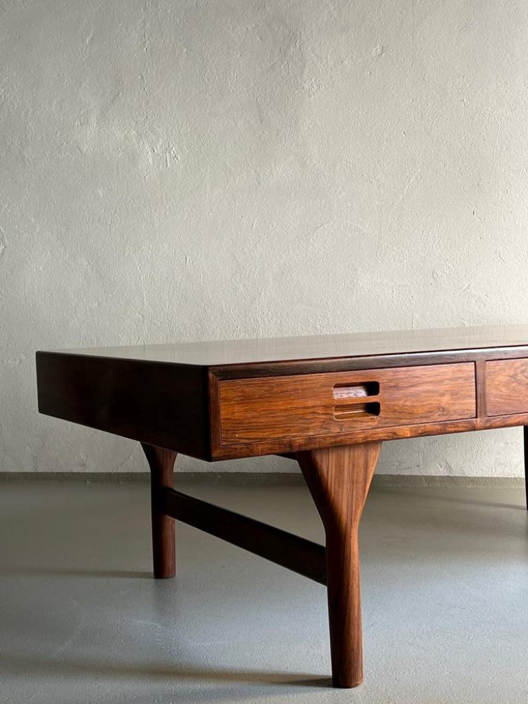 Iconic rosewood table with three drawers by Nanna Ditzel for SØREN WILLADSEN designed in 1950s. Heavy item.

Additional information:
Country of manufacture: Denmark
Period: 1950s
Dimensions: 145 W x 75 D x  46 H cm
H (table top) 12 cm / Chest - 55 W