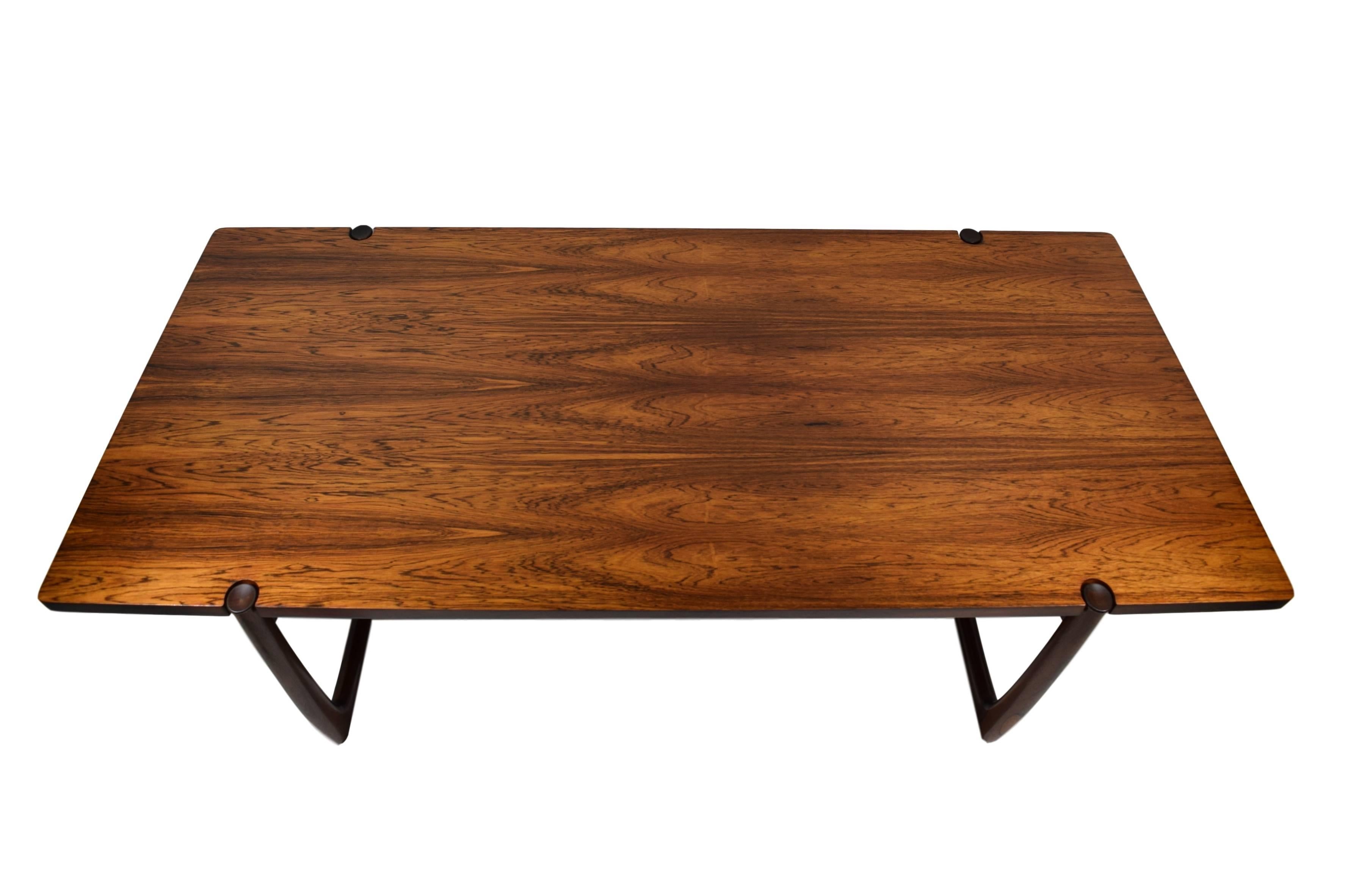 A Danish midcentury rosewood coffee table by Peter Hvidt (1916-1986) & Orla Mølgaard (1907-1993). Model 596. Produced by France & Son. Rosewood veneer and solid rosewood legs. The table is newly refinished and has expressive rosewood grains.