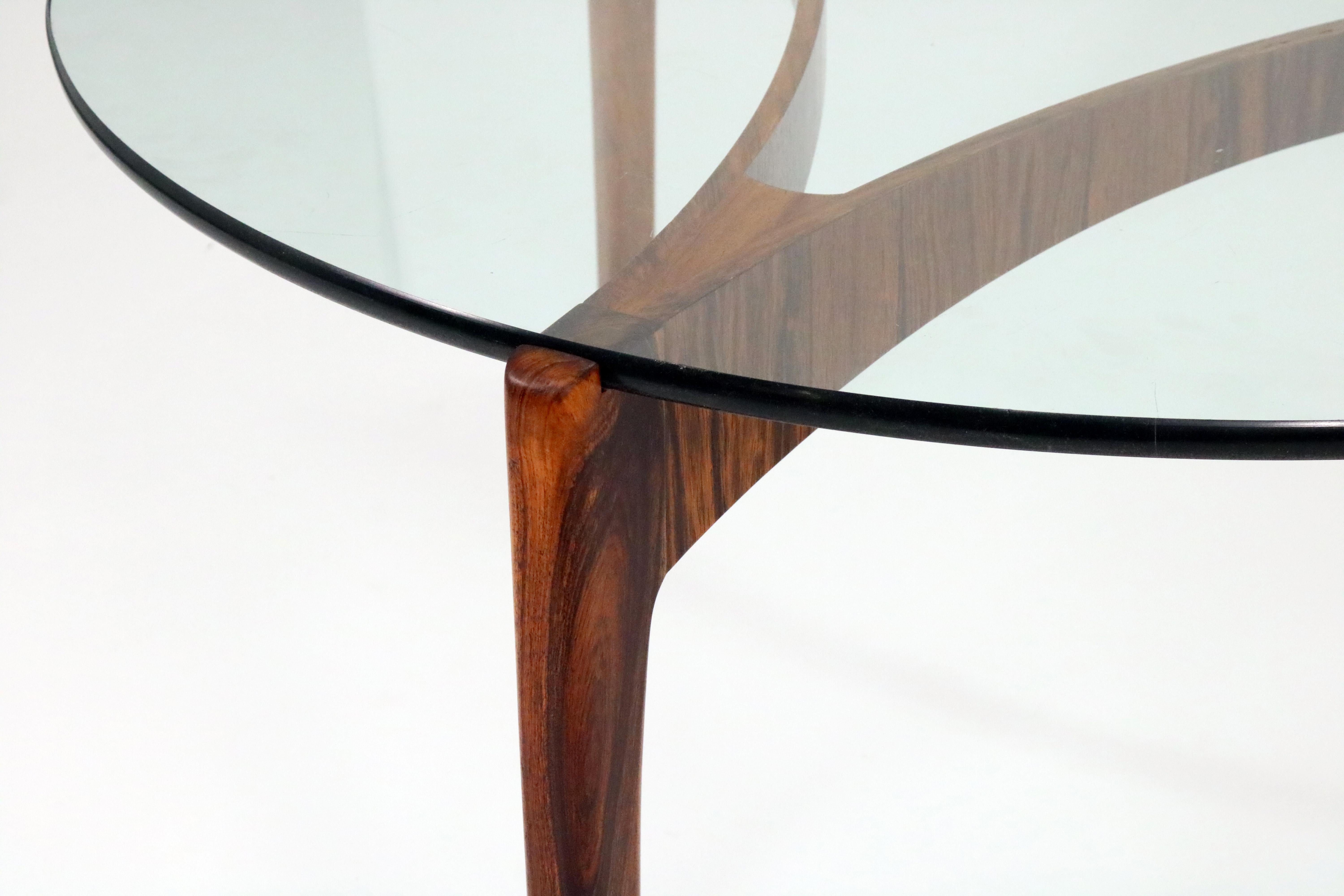 A strikingly elegant rosewood coffee table with glass top by Sven Ellekaer for Christian Linneberg.