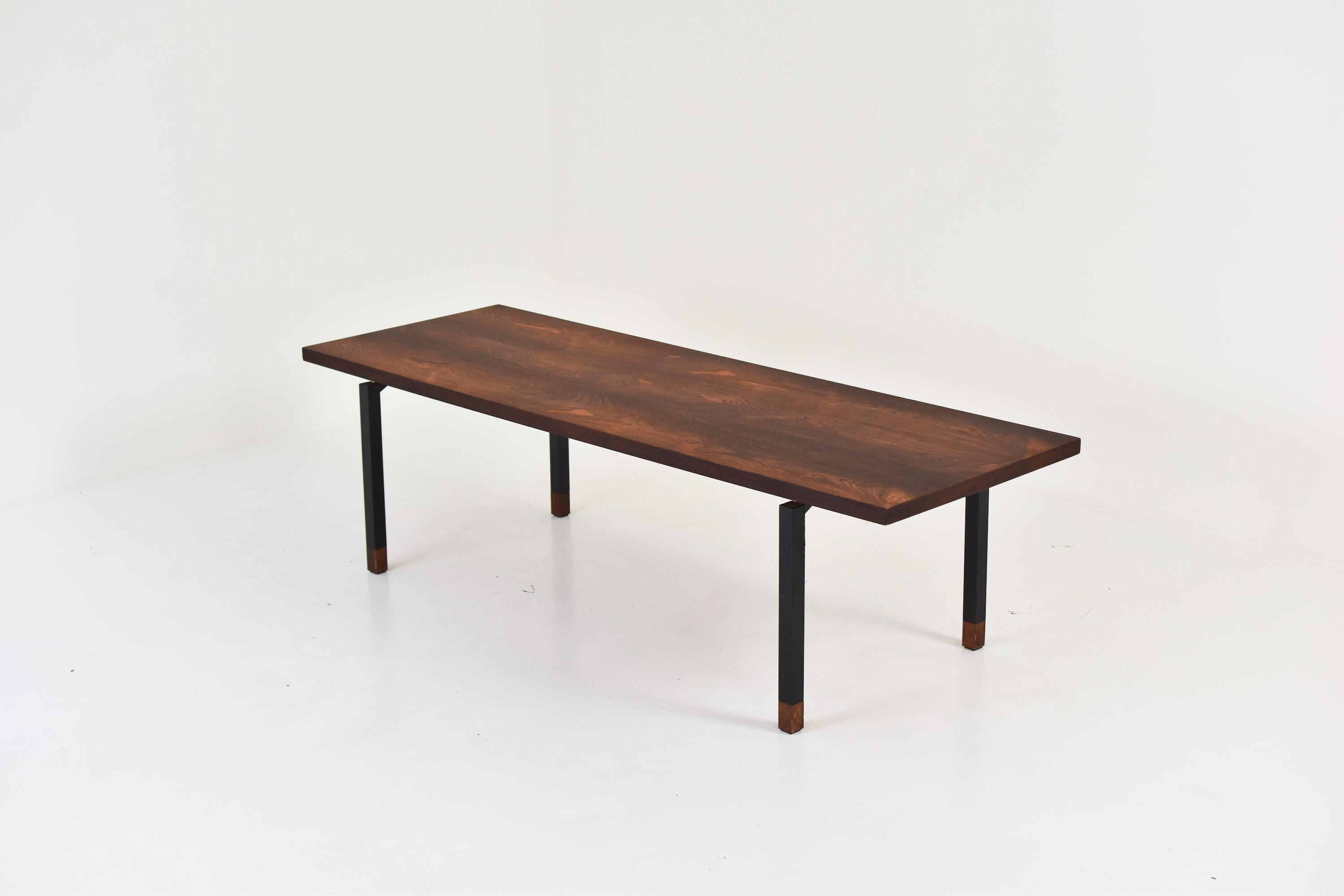 Rosewood coffee table from Denmark 1950’s. This Modern coffee or side table features a black lacquered steel frame with rosewood socks and a floating rosewood top with an amazing grain ! In the manner of Johannes Aasbjerg for Illums Bolighus.
